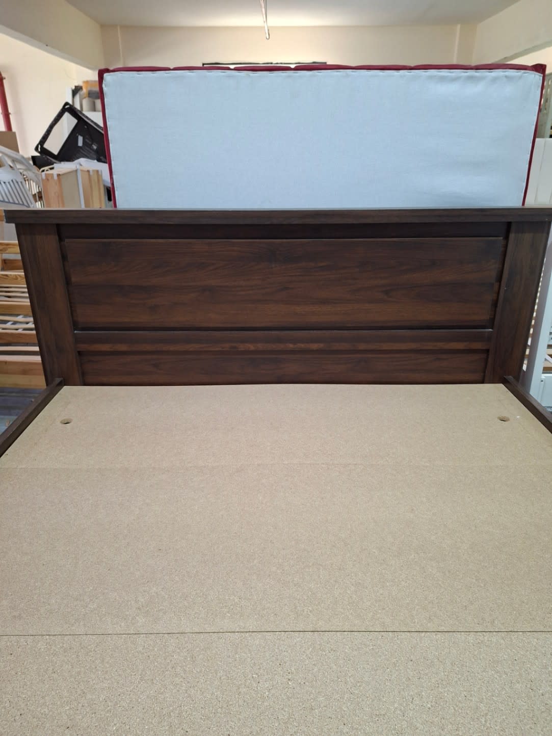 Headboard close-up of used queen bed frame dark walnut panelled design at Bufaisal Ajman