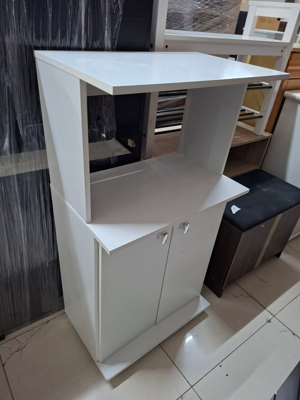 Used white microwave stand with storage cabinet, another angle showing chrome handles