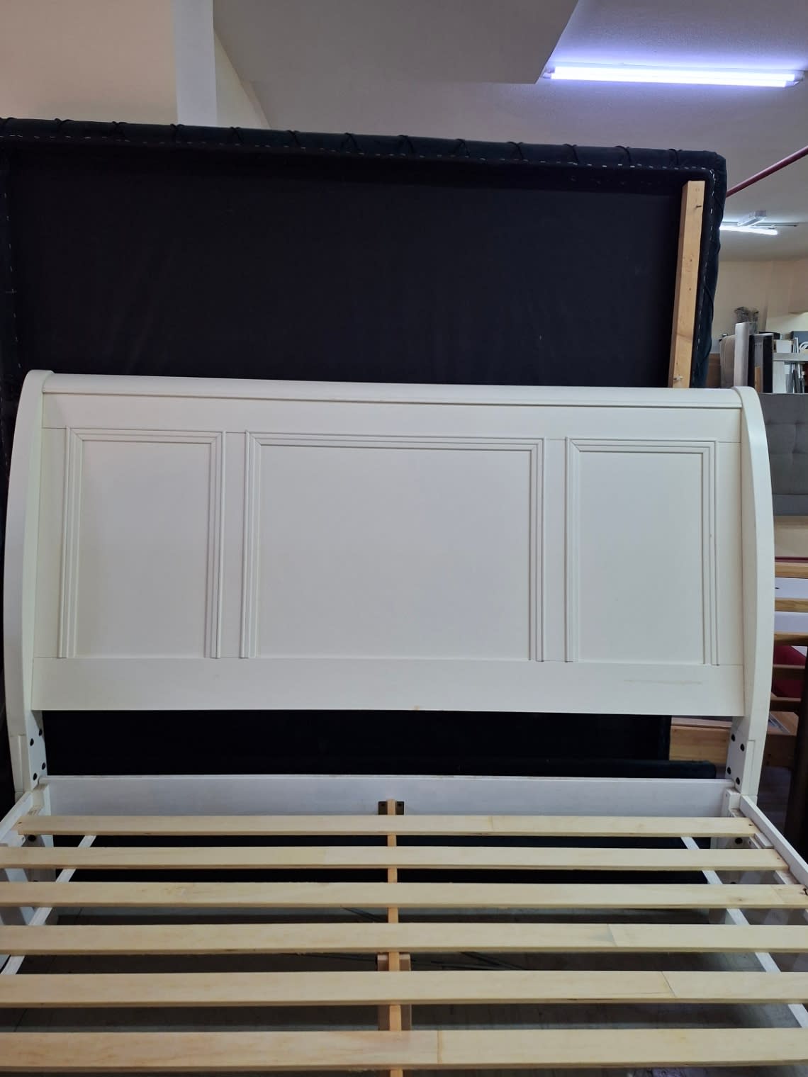 Headboard close-up of used white panelled sleigh bed frame at Bufaisal Shop C Ajman