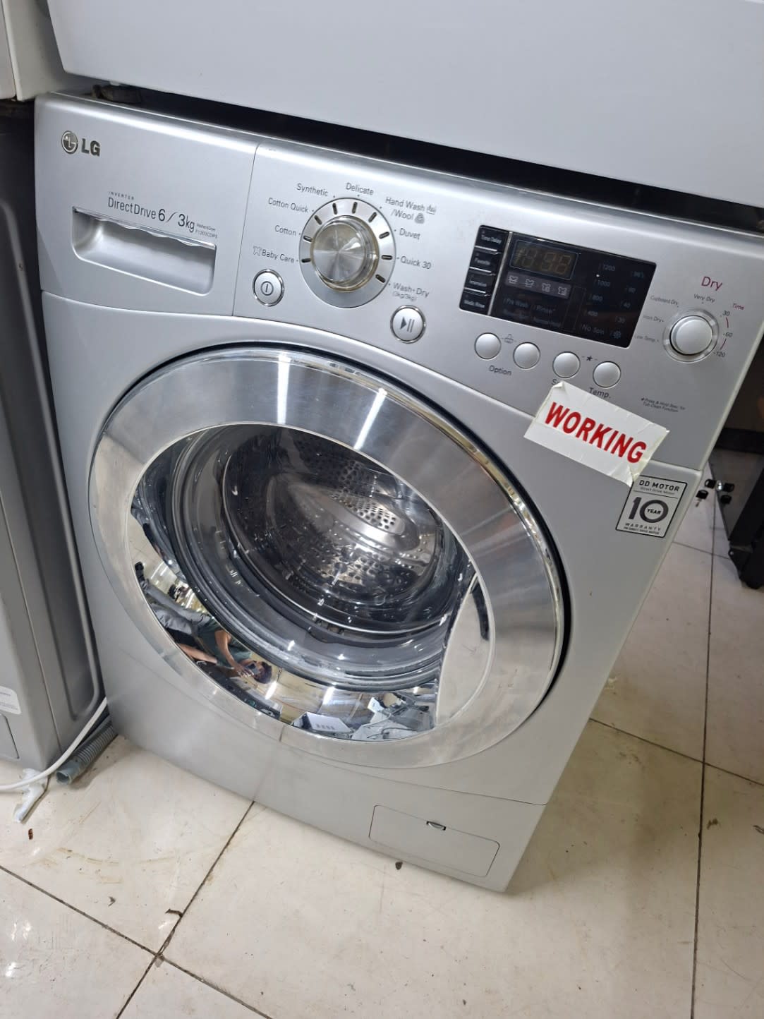 Front view of used LG 6kg washer dryer combo with working sticker, good condition, Shop C Ajman