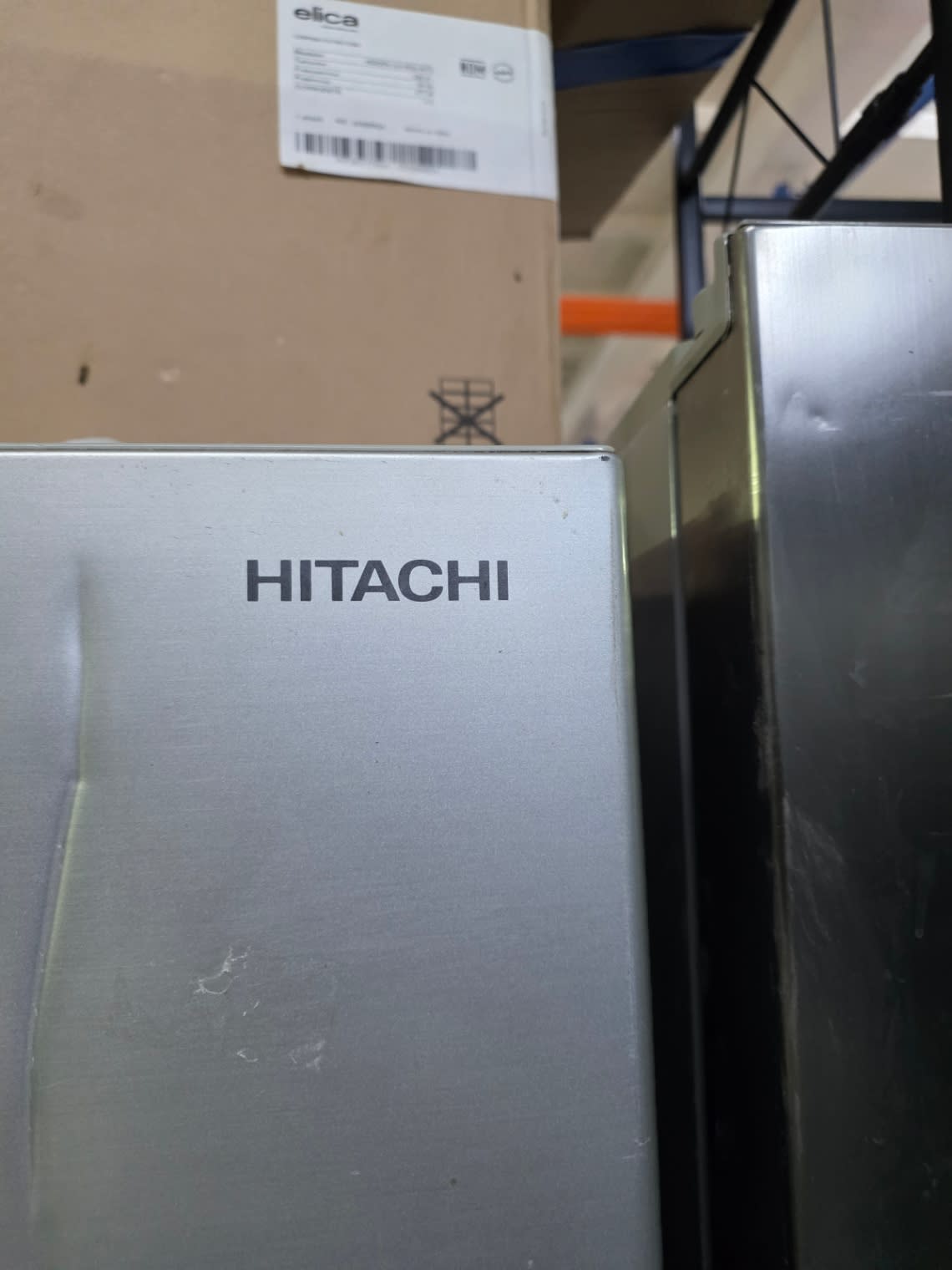 Bufaisal barcode label for used Hitachi top-mount refrigerator — label unreadable in photo