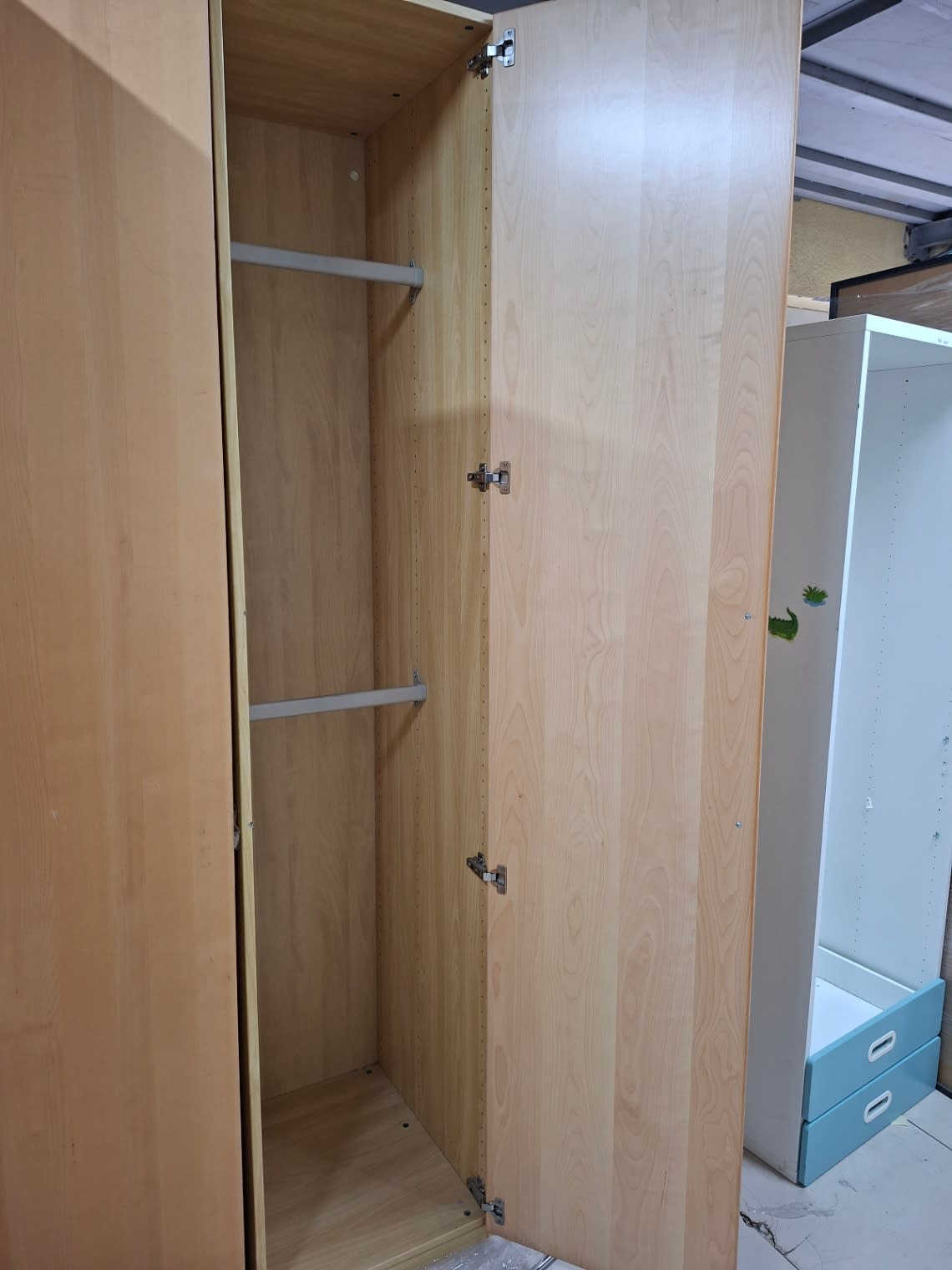 Open door view of used 2-door beech laminate wardrobe showing full interior height and hinges