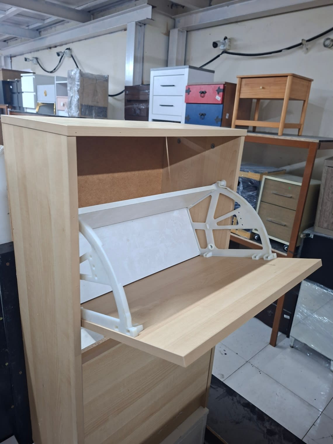 Open lower compartment detail of used 2-tier flip-door shoe cabinet showing fold-out frame in good condition
