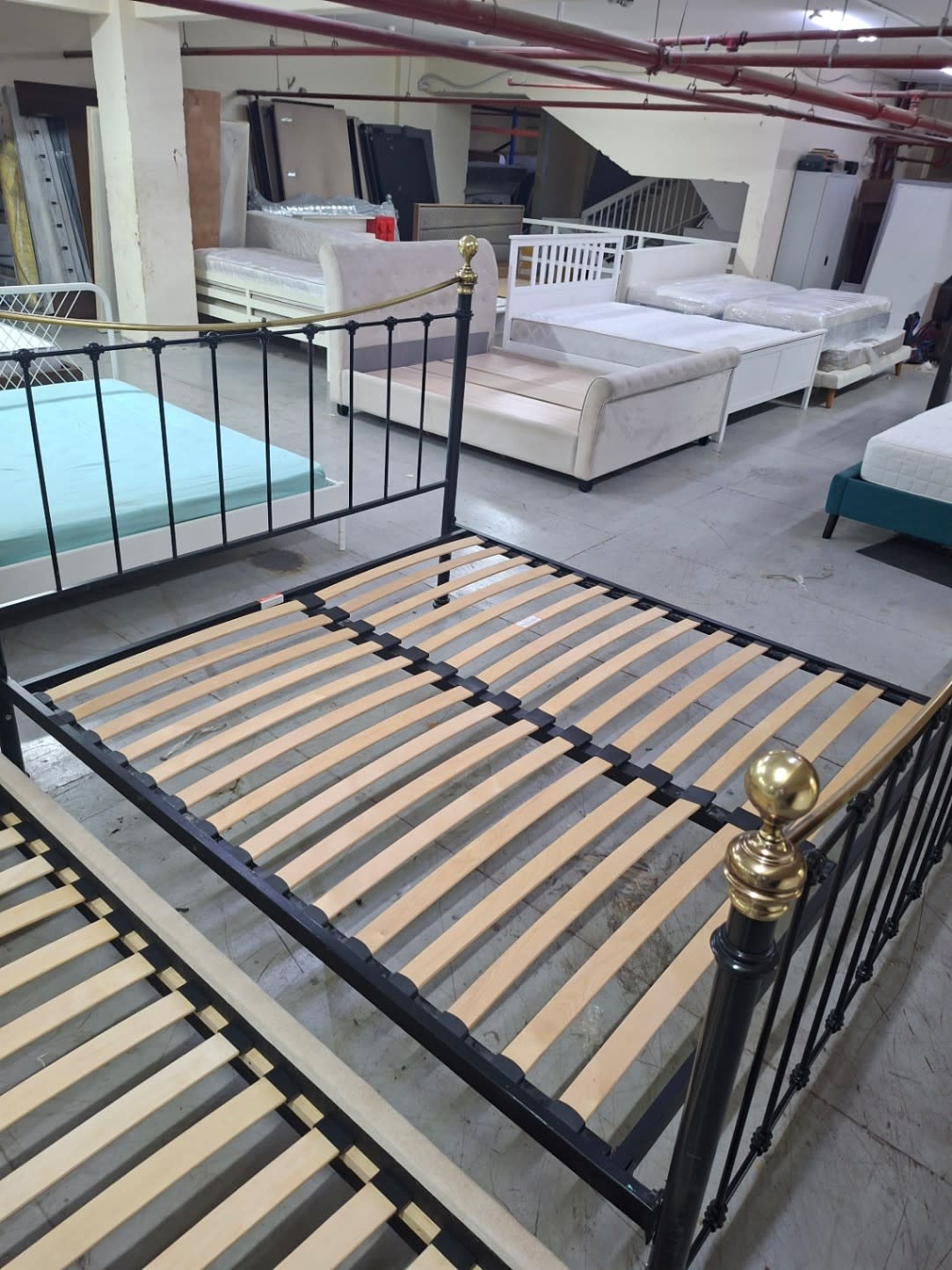 Top-down view of used queen metal bed frame showing full wooden slat layout at Bufaisal Ajman