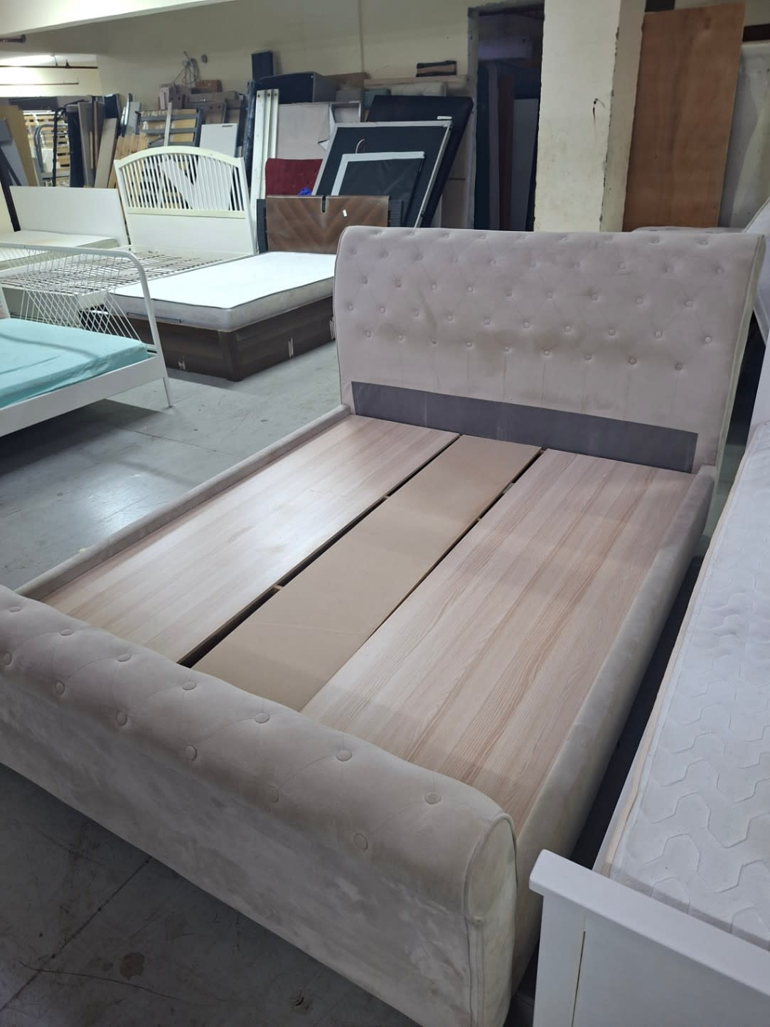 Overhead angle of used cream velvet sleigh bed frame showing full slatted base at Bufaisal Ajman
