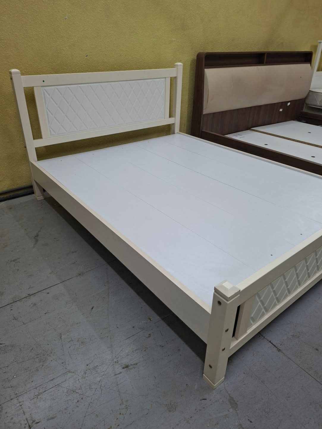 Three-quarter view of used white queen bed frame showing full frame structure at Bufaisal Shop C Ajman