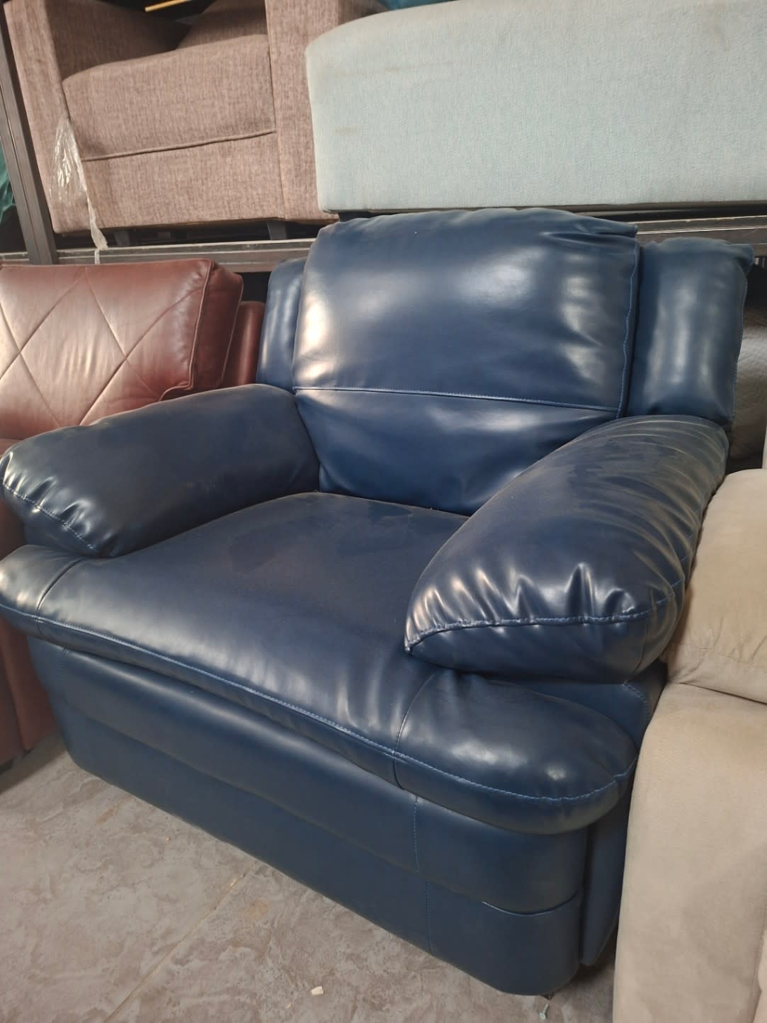 Additional front angle of used navy blue faux leather armchair good condition Bufaisal