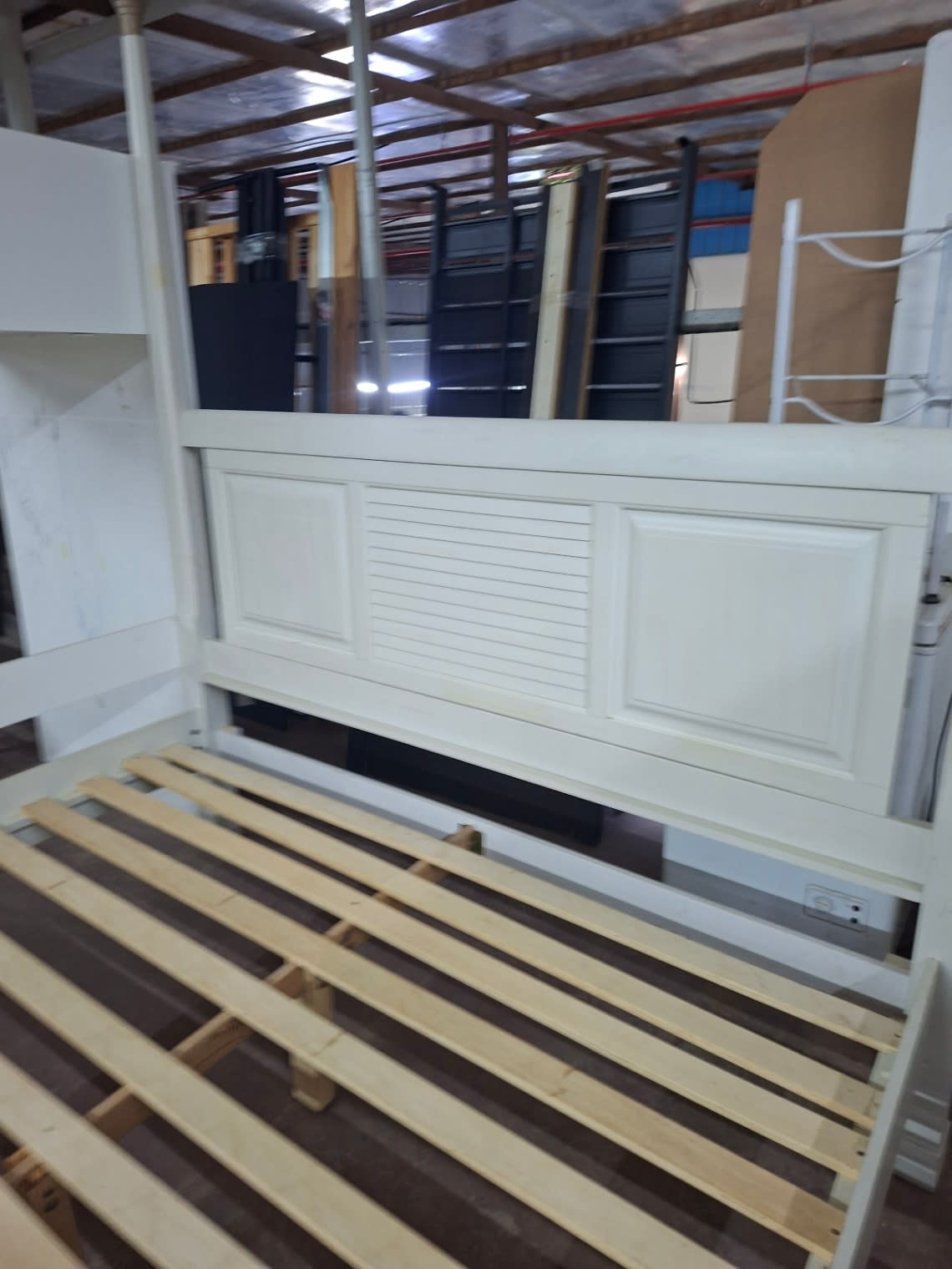 Close-up of used white four-poster bed frame headboard panel detail at Bufaisal Shop D Ajman