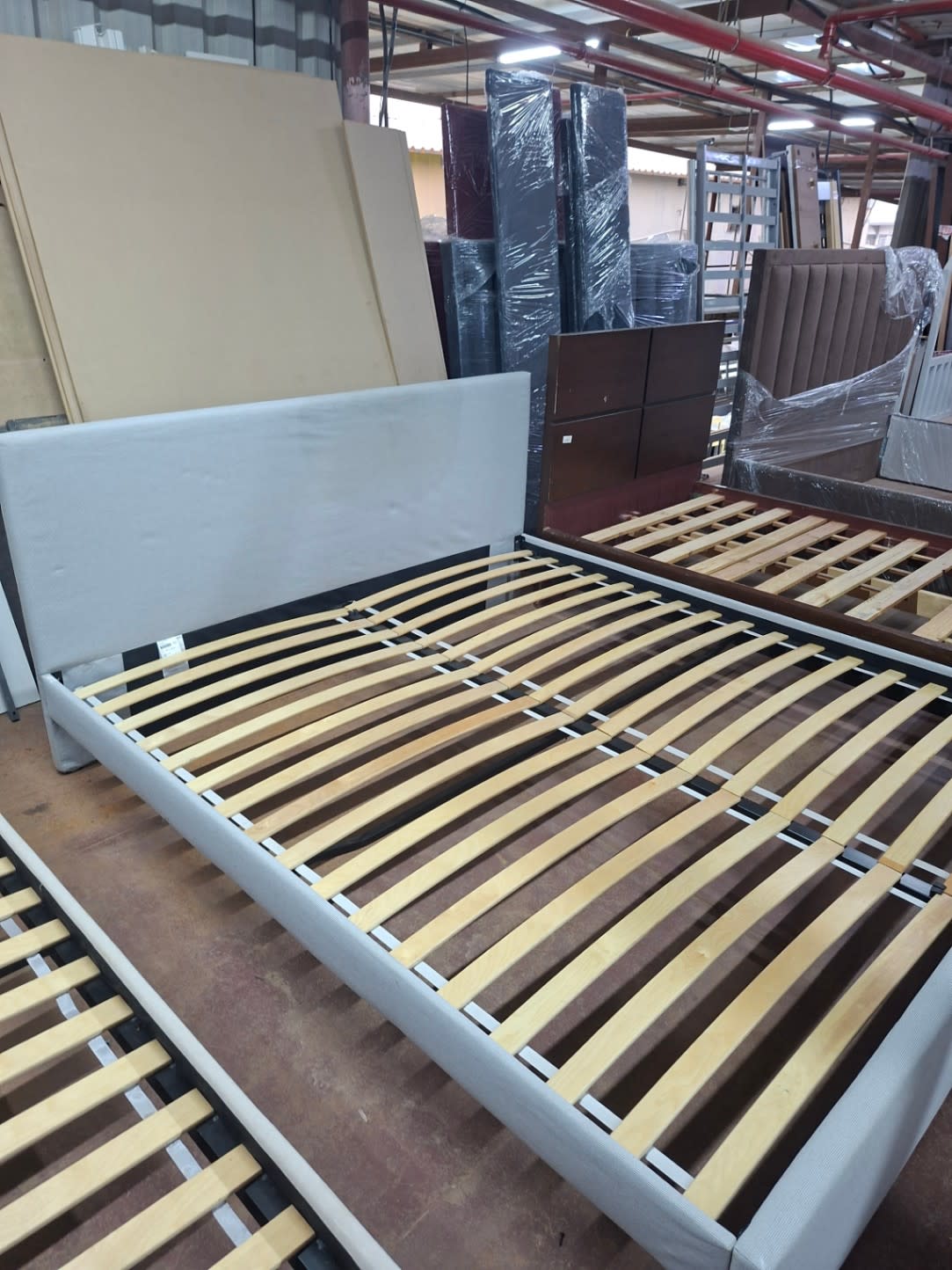 Full view of used grey king bed frame with intact wooden slats at Bufaisal Shop D Ajman