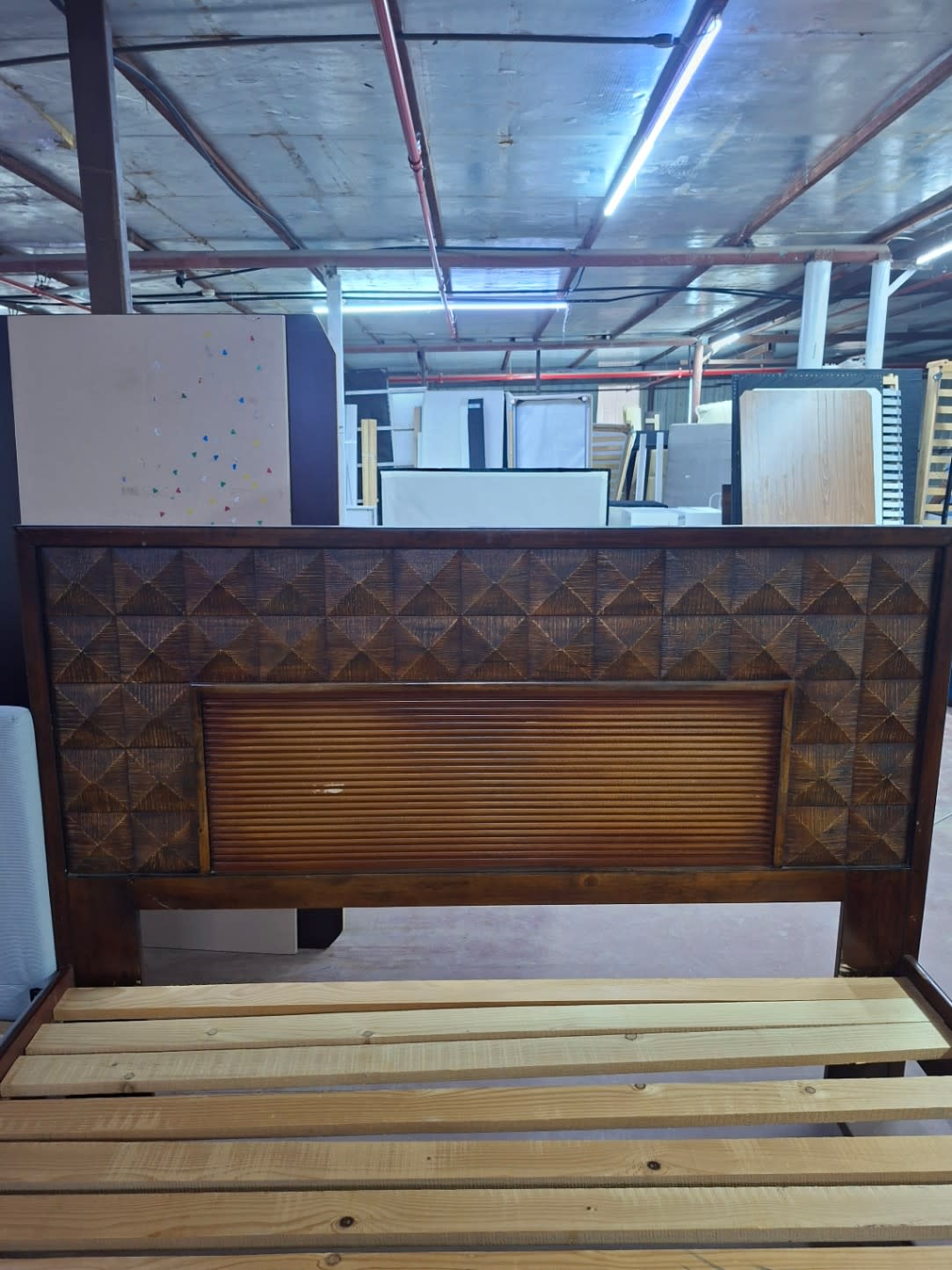 Front view of carved diamond-pattern headboard on used king bed frame at Bufaisal Shop D Ajman