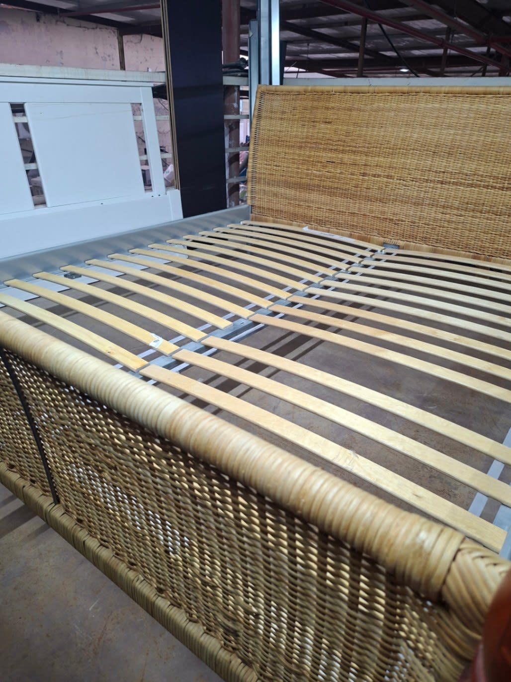 Close-up of rattan wicker footboard and side rail of used IKEA bed frame at Bufaisal Ajman