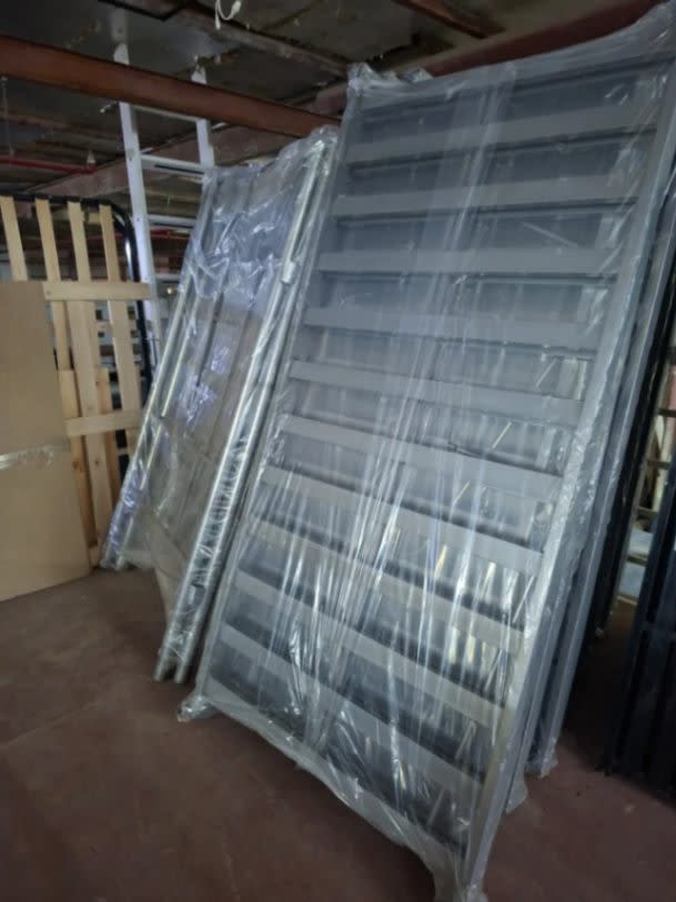 Bufaisal barcode label for new dark grey metal slatted bed frame at Shop C Ajman
