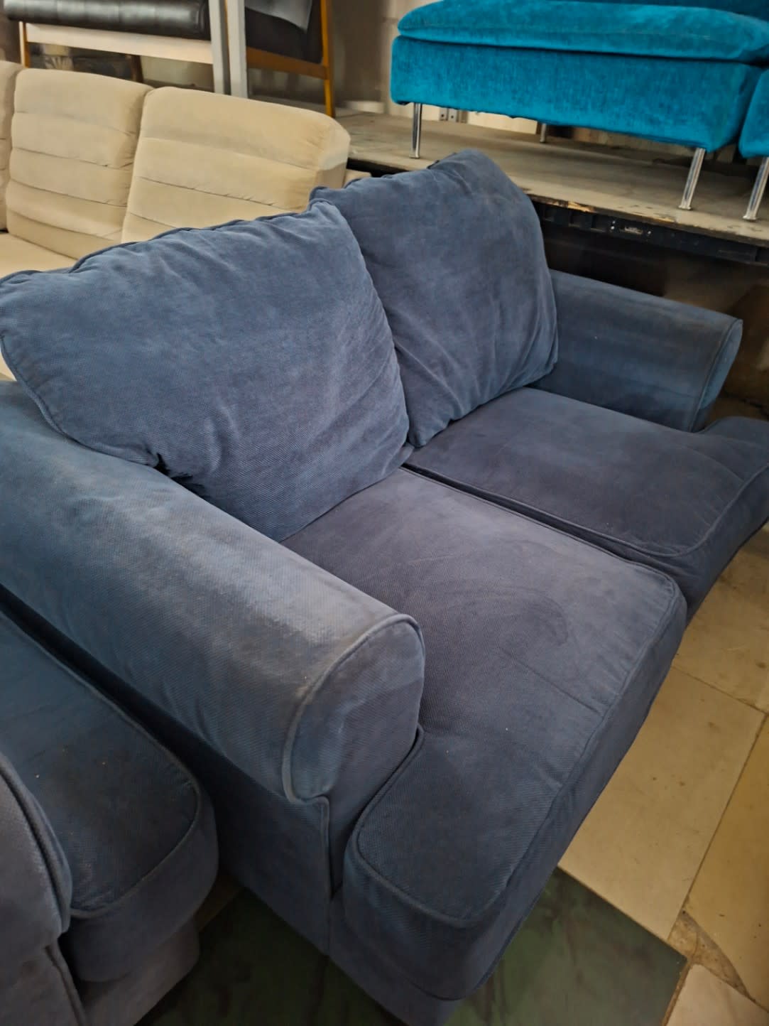Second front view of used navy blue 2-seater fabric sofa with back cushions at Bufaisal Ajman
