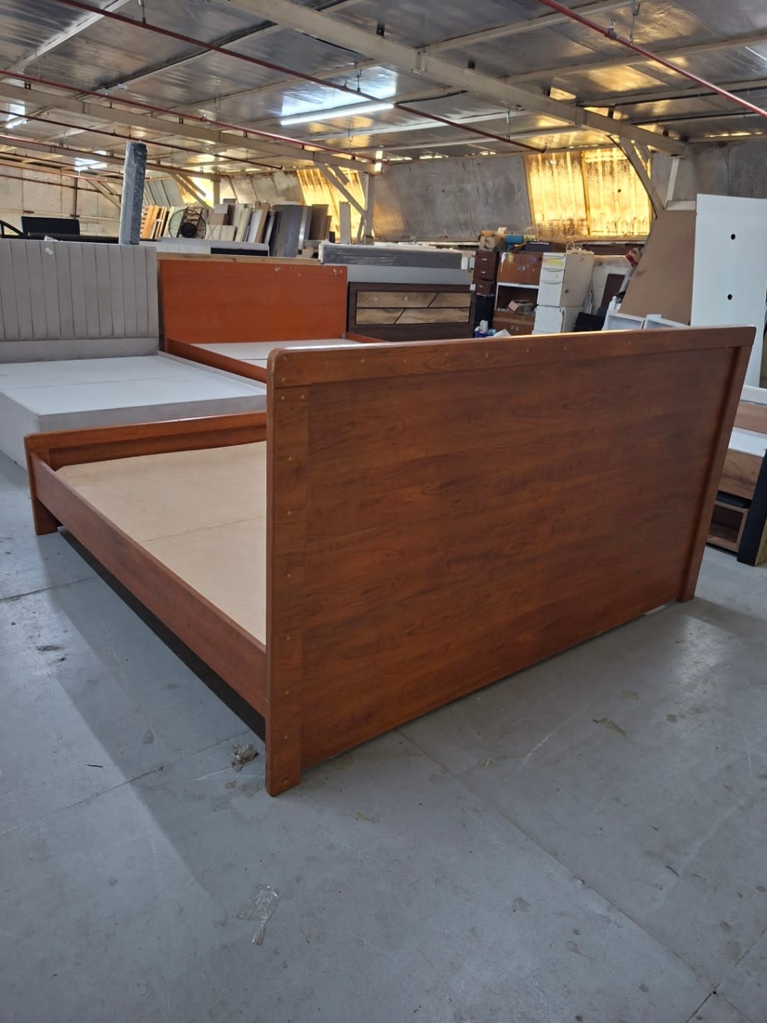 Rear side view of used king bed frame showing footboard and storage base at Bufaisal Ajman