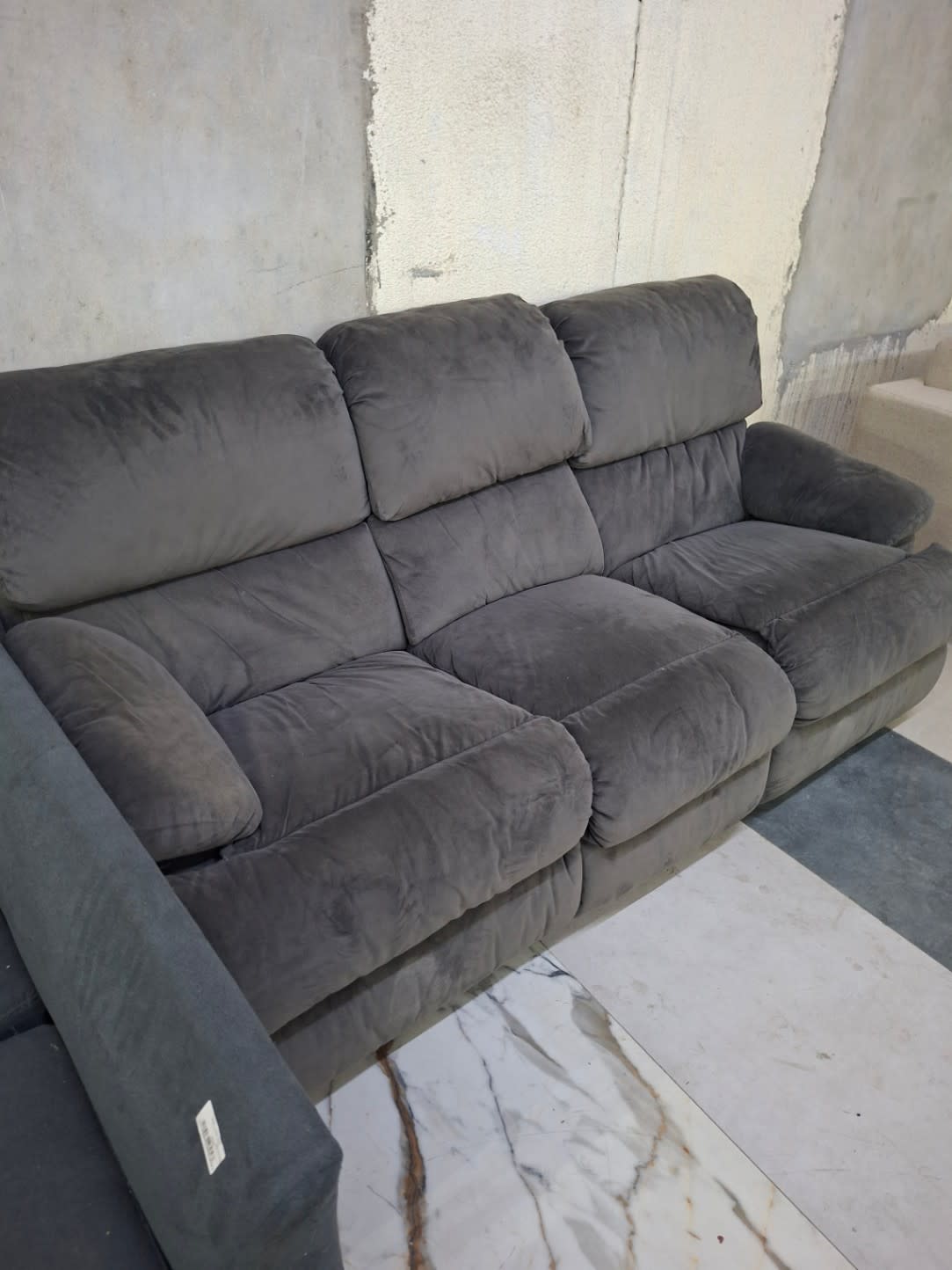 Bufaisal barcode label on used 3-seater recliner sofa at Shop E Ajman