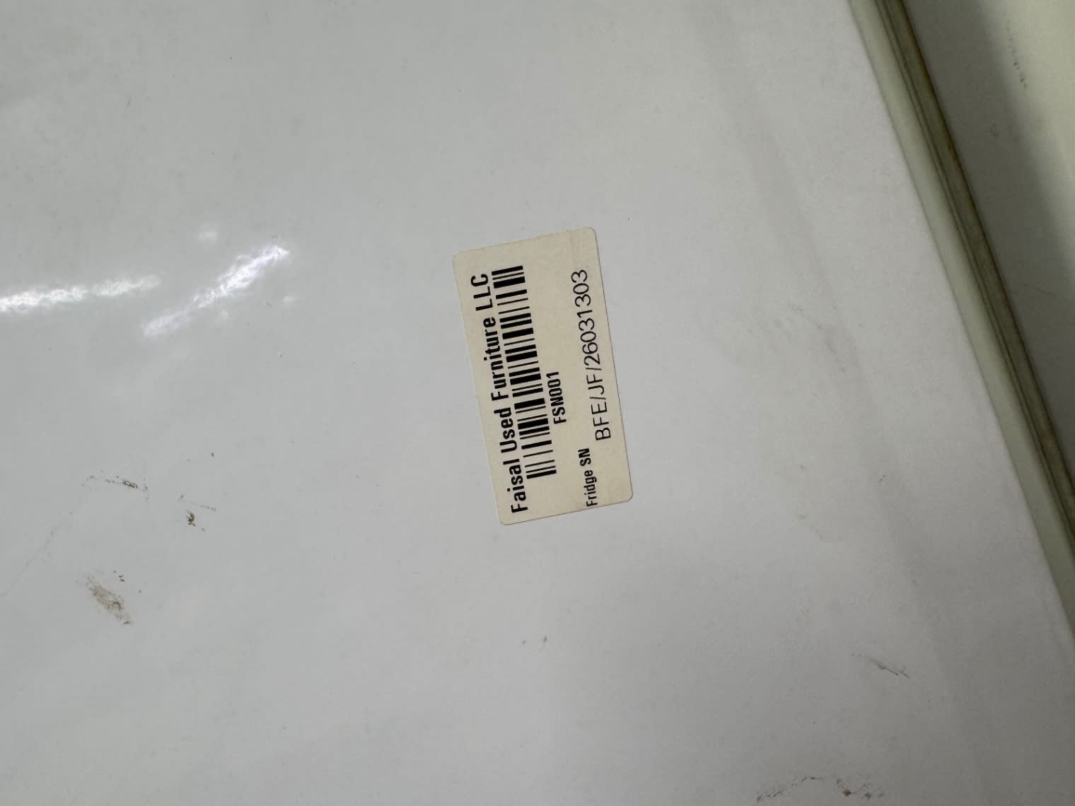 Bufaisal barcode label BFE/JF/26031303 on used Whirlpool bottom-freezer refrigerator