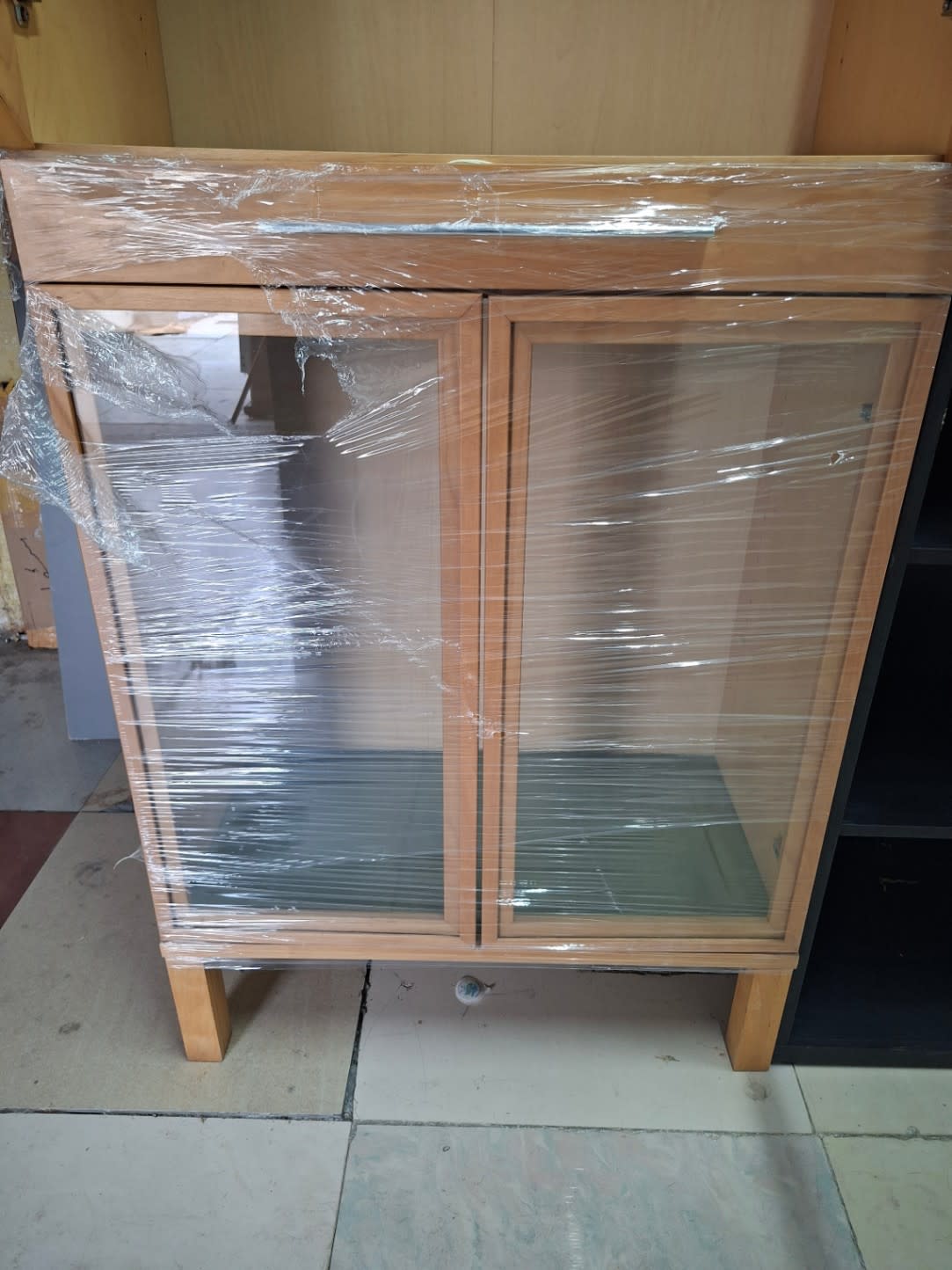 Lower unit of used glass-door display cabinet light oak with glass shelves at Bufaisal Ajman