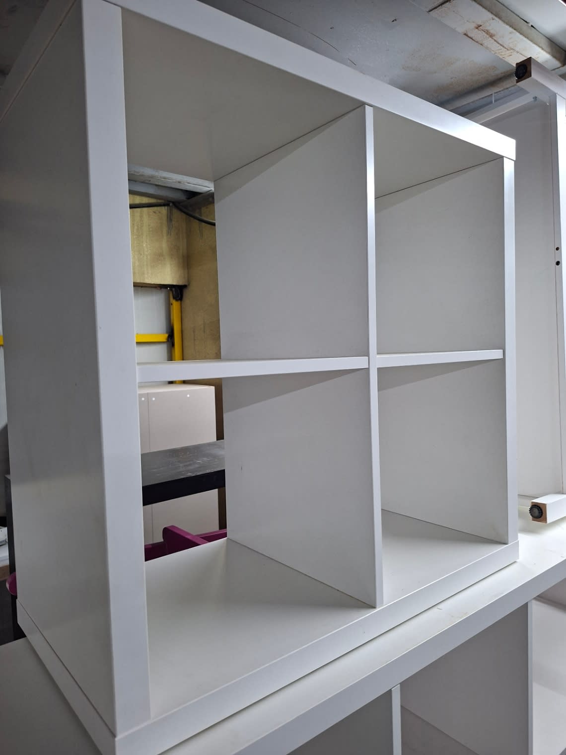Barcode label photo for used white 4-cube shelving unit at Bufaisal Ajman