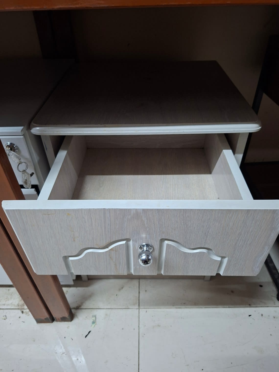 Top drawer of used 3-drawer bedside table open showing interior condition, Bufaisal Ajman