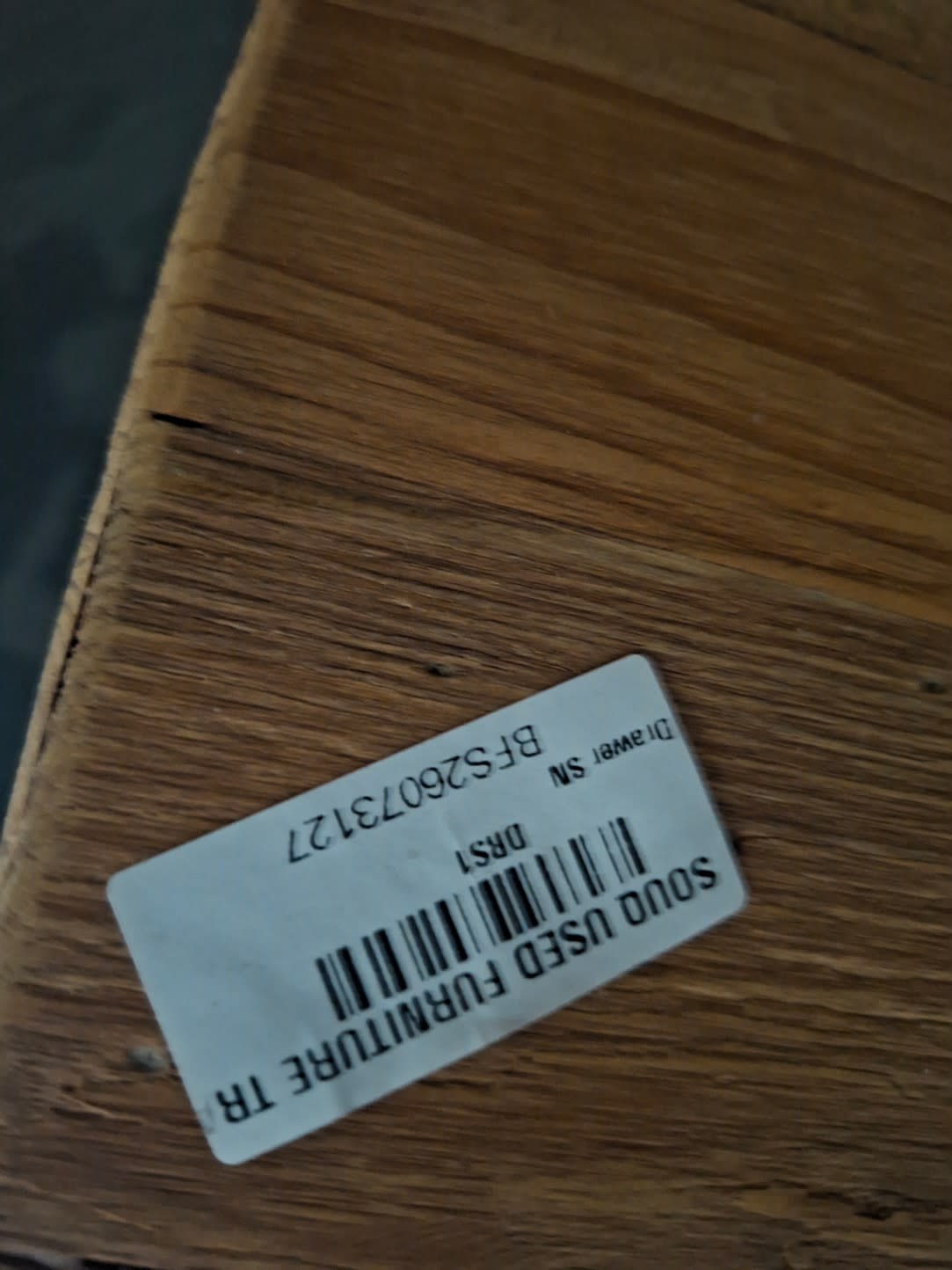 Bufaisal barcode label BFS26073127 for used wooden bedside table at Shop C Ajman