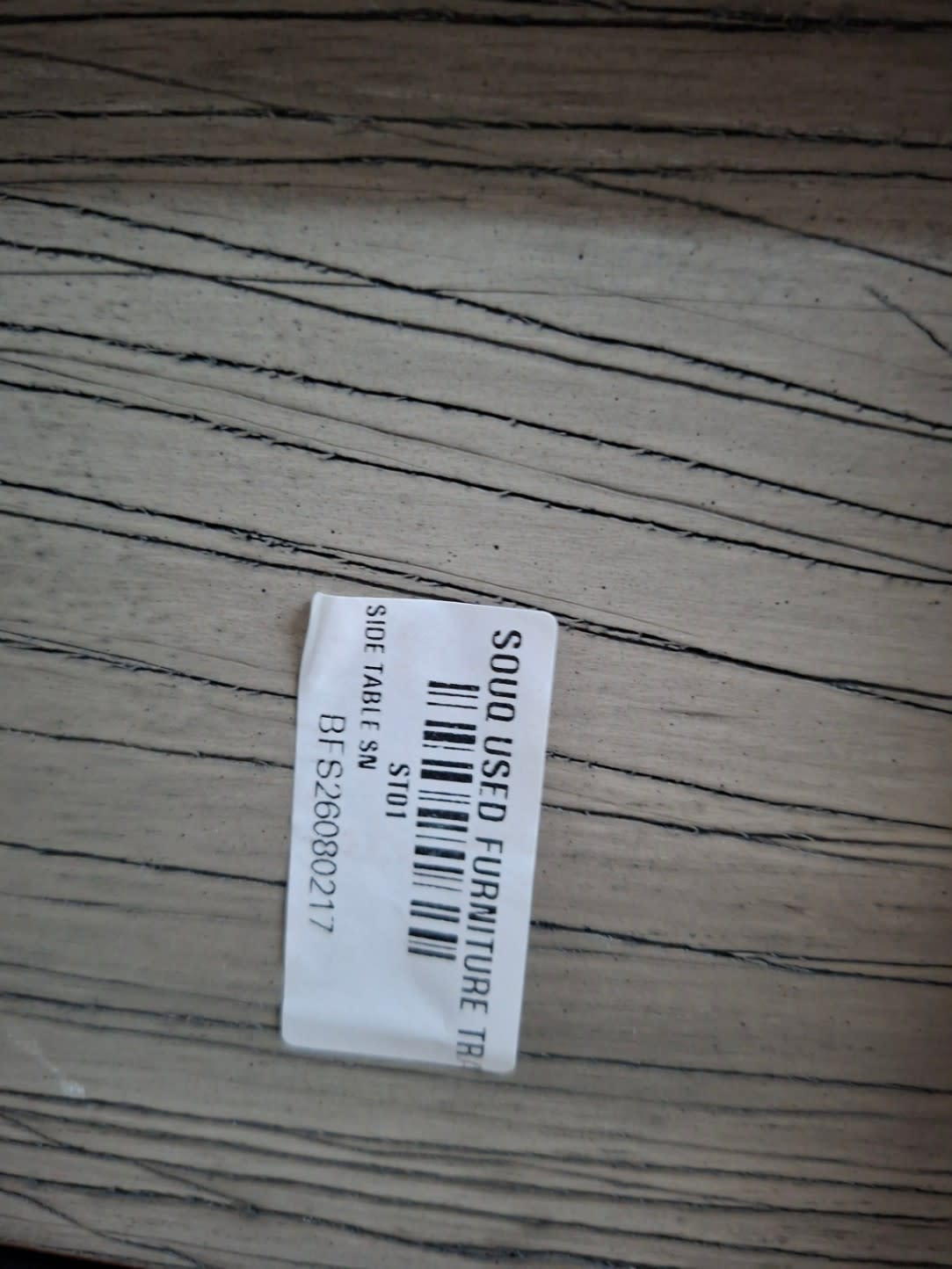 Bufaisal barcode label BFS26080217 for used 2-drawer bedside table at Shop C Ajman