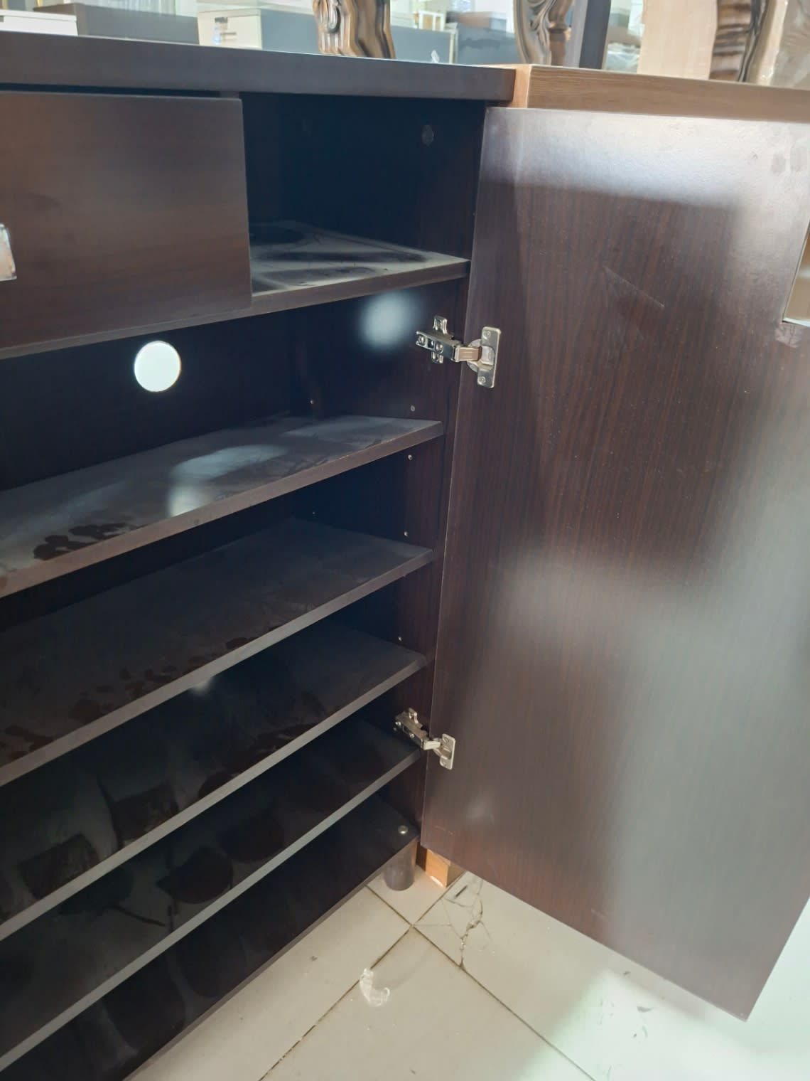 Side detail of used dark brown shoe cabinet showing door hinge and interior shelves at Bufaisal Ajman