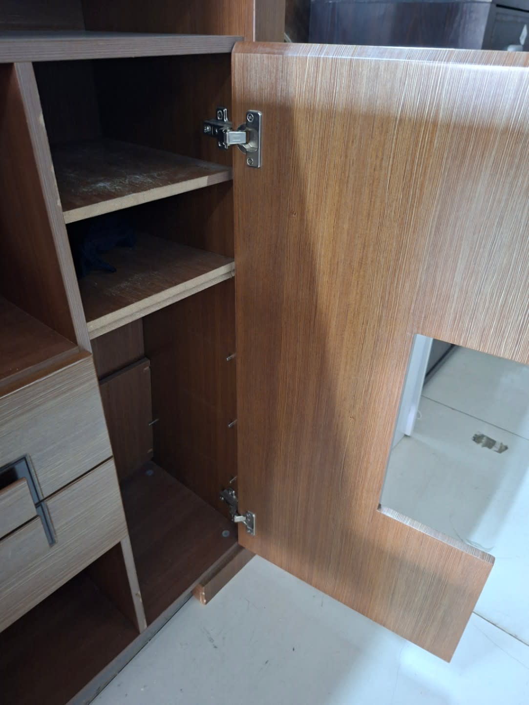 Side door hinge detail of used walnut brown shoe cabinet showing hardware condition