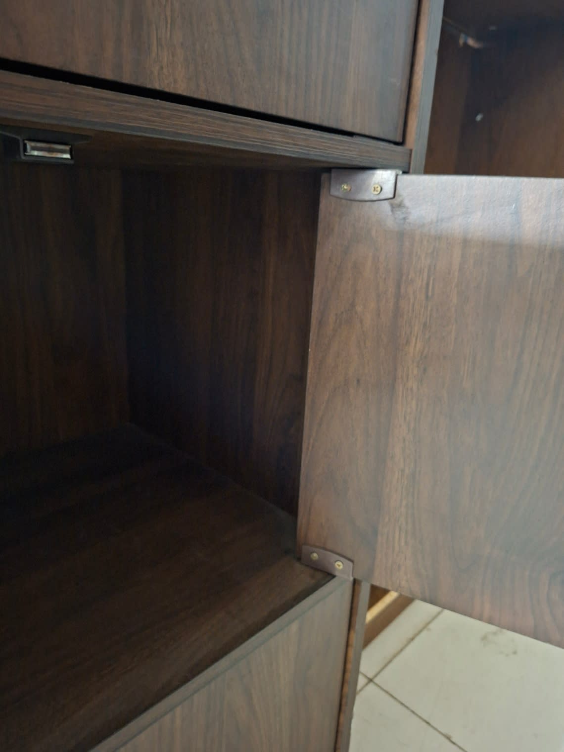 Close-up of hinge and door panel detail on used 6-door storage cabinet showing minor scuff marks