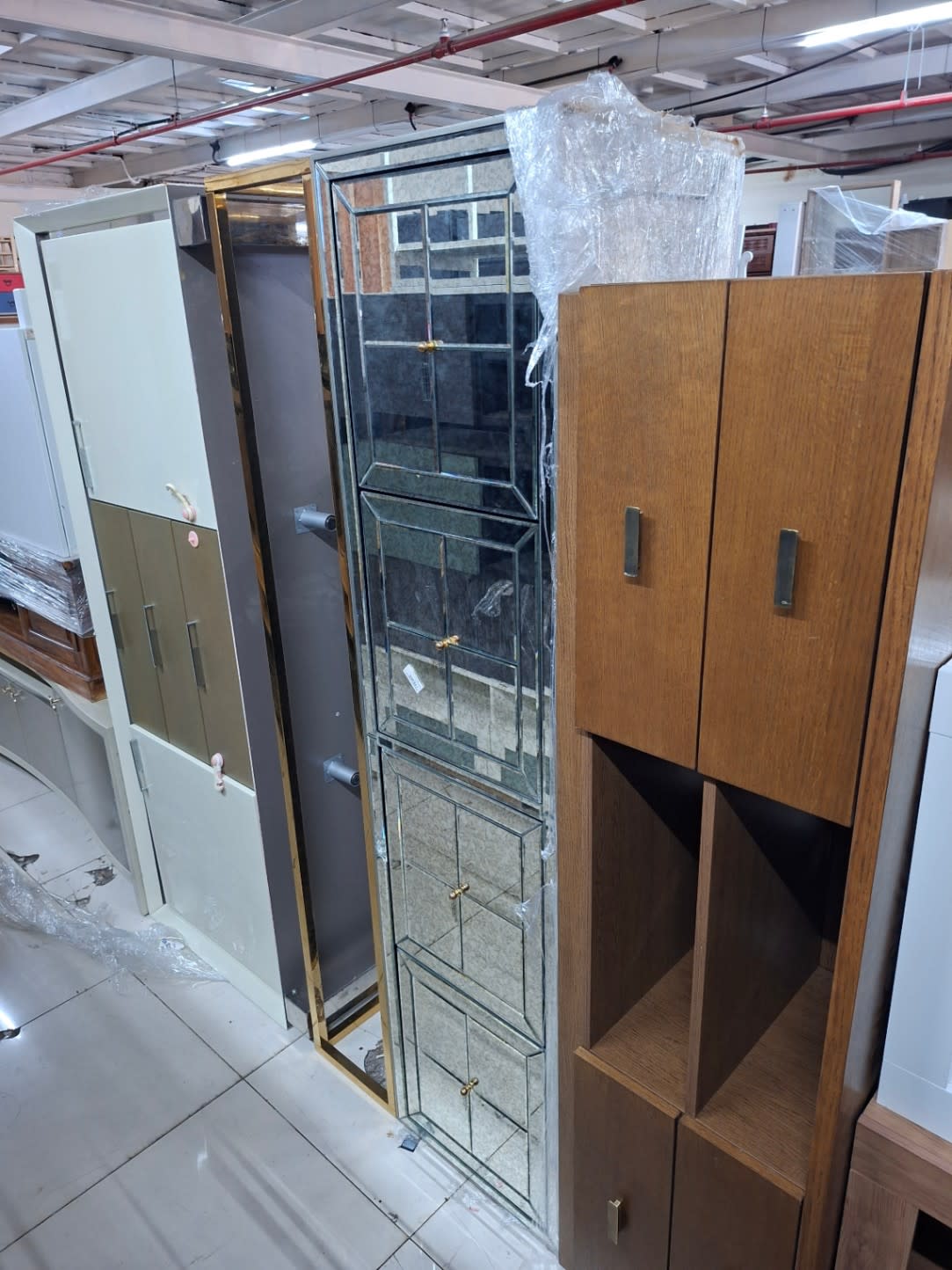 Showroom view of used tall storage cabinet brown wood-finish available at Bufaisal Ajman
