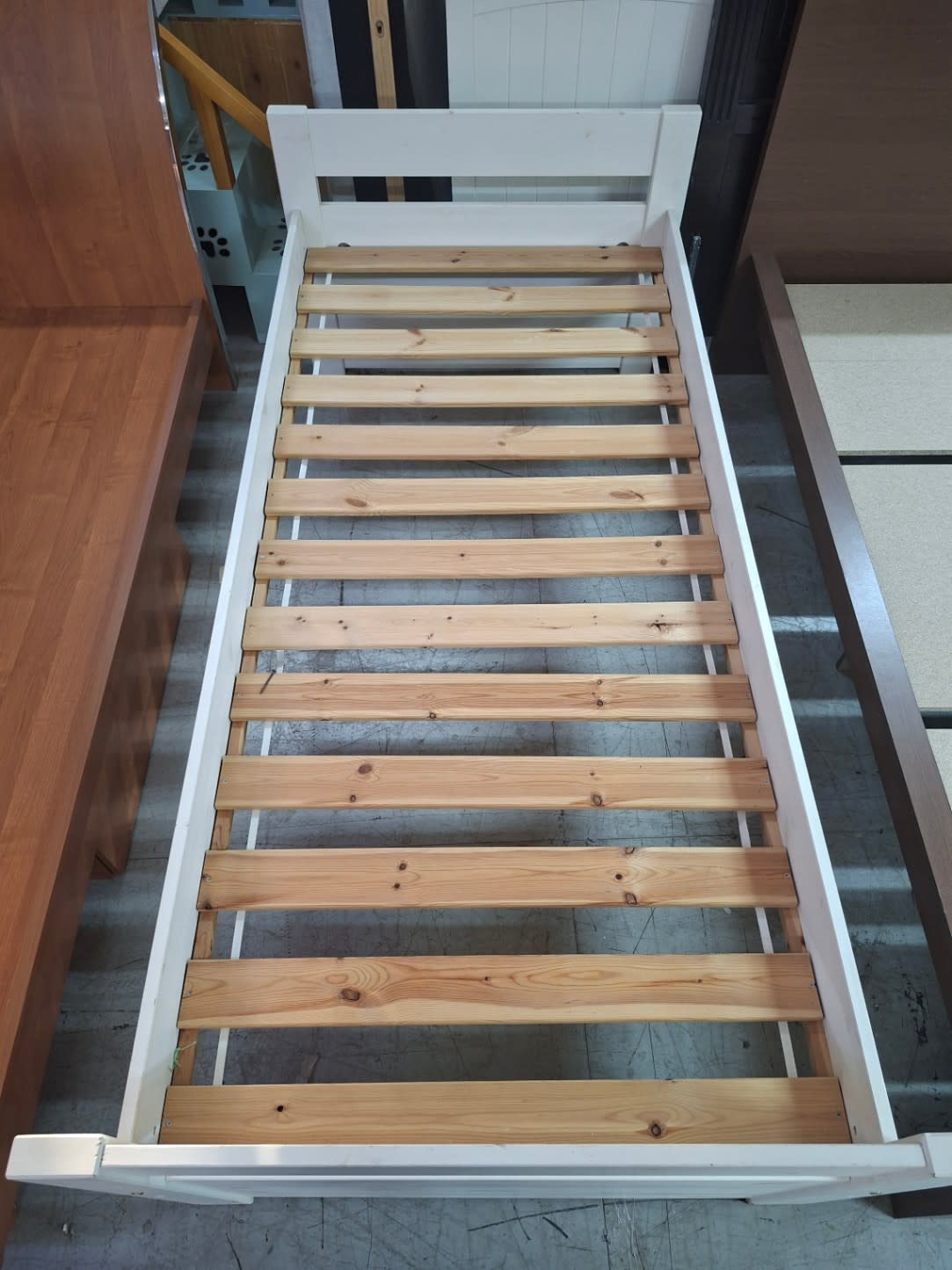 Top-down view of used white single bed frame showing full slat layout at Bufaisal Shop C Ajman