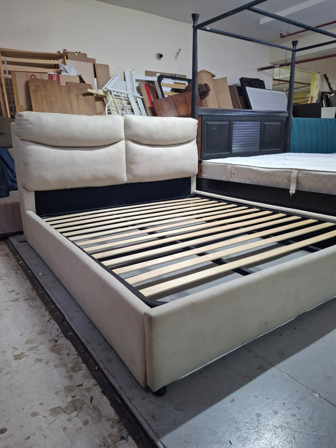 Used king bed frame with cream cushioned headboard at Bufaisal Shop C Ajman