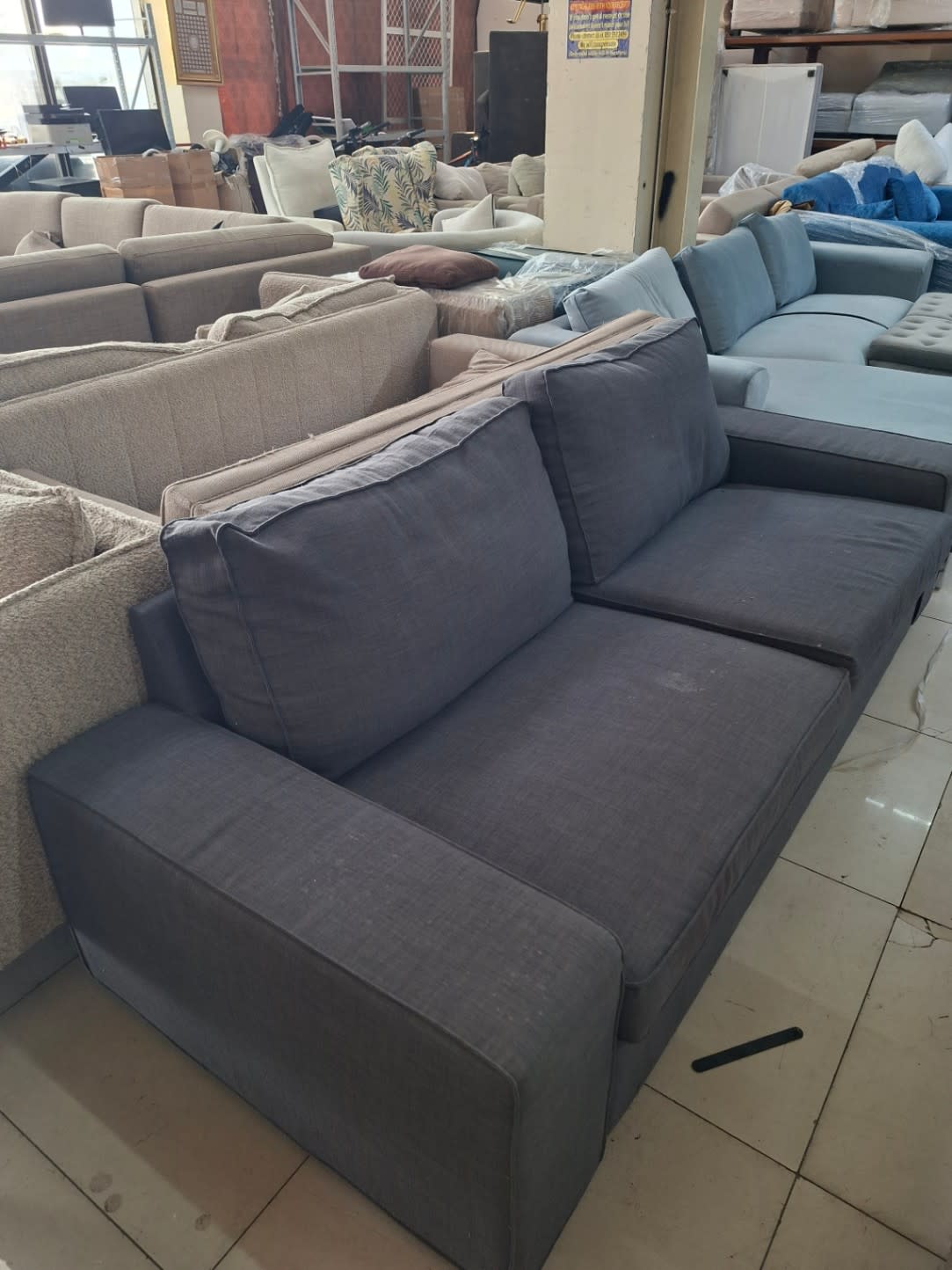 Bufaisal barcode label for used dark grey 3-seater sofa at Shop C Ajman