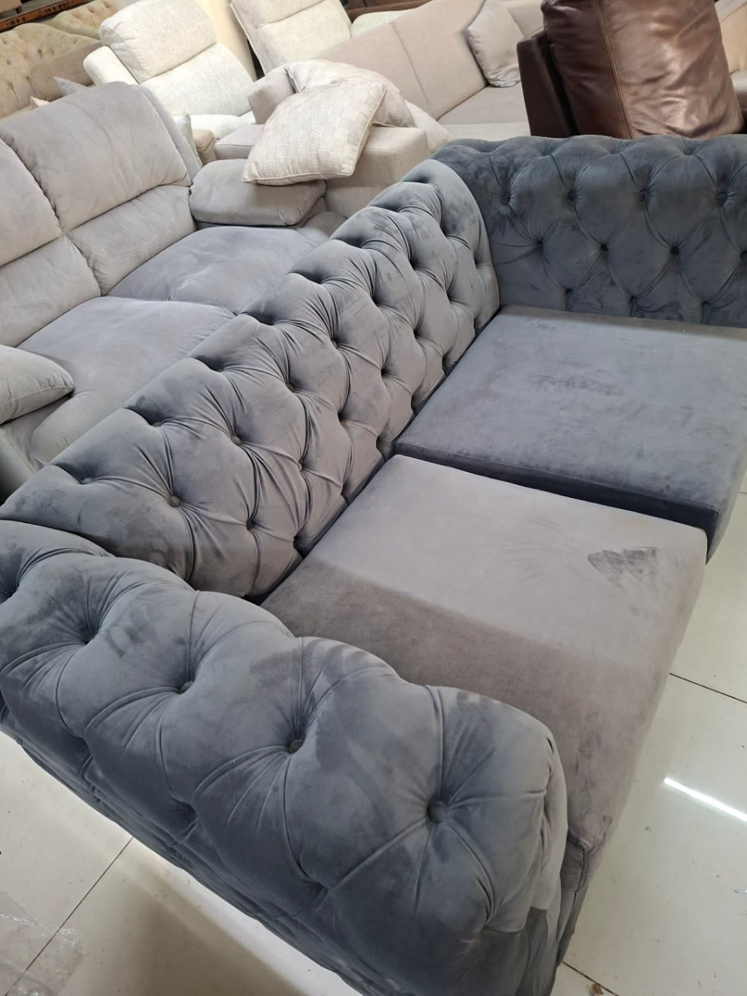 Barcode label for used grey Chesterfield 2-seater sofa at Bufaisal Ajman — label unreadable