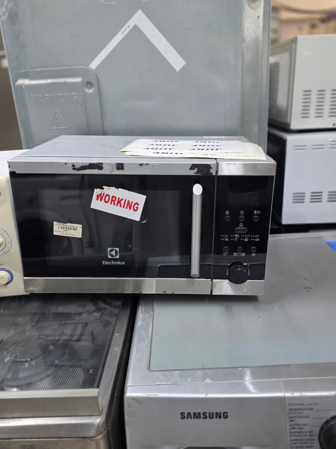Bufaisal barcode label for used Electrolux microwave oven — barcode unreadable in photo