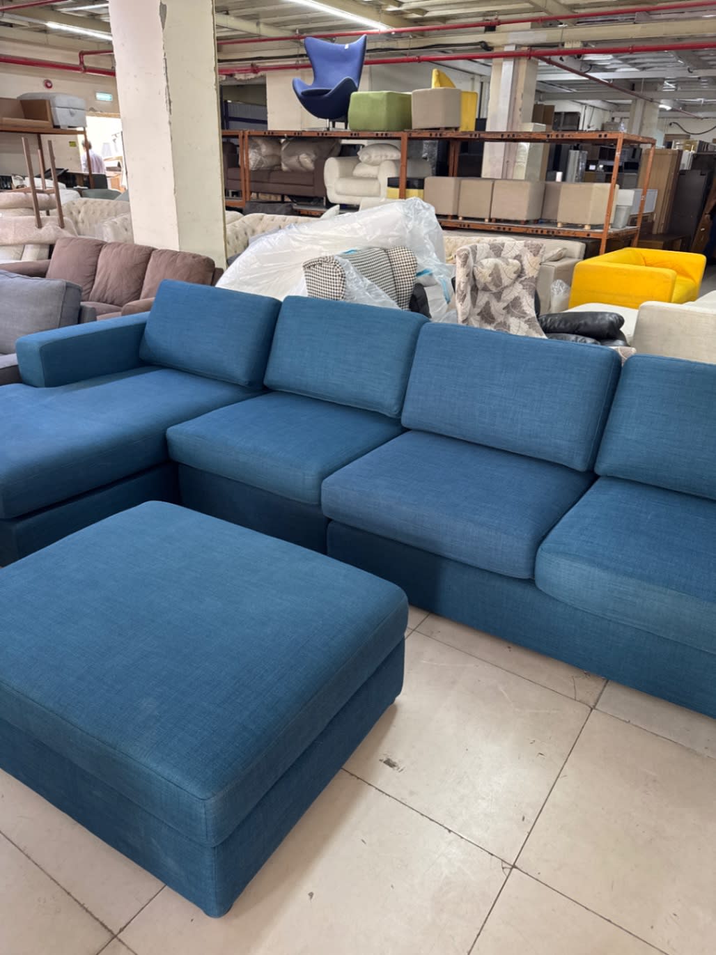 Side angle of used teal blue L-shape sectional sofa with ottoman at Bufaisal Shop C Ajman