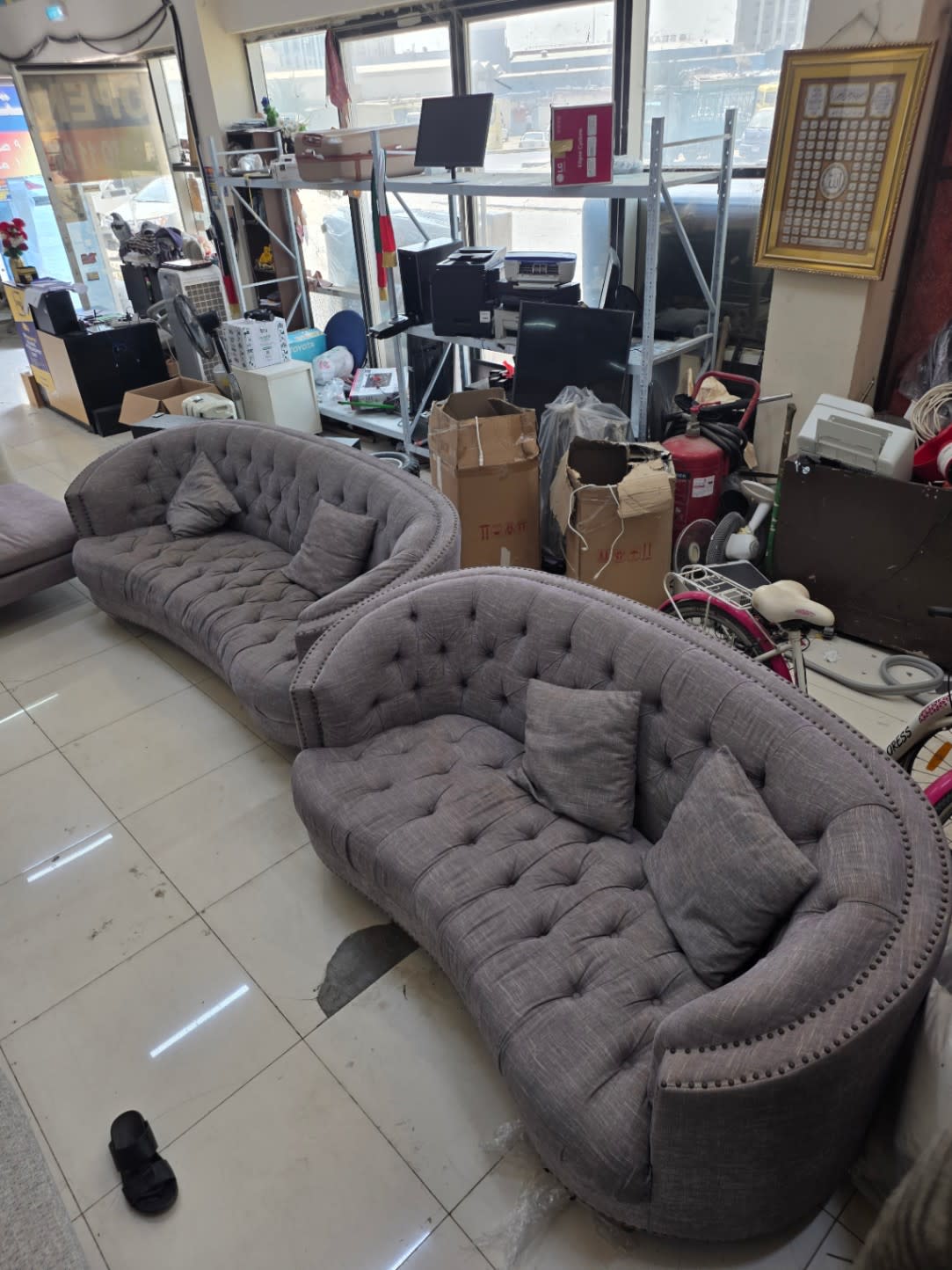 Used curved grey tufted sofa set at Bufaisal Shop C Ajman — barcode label not readable