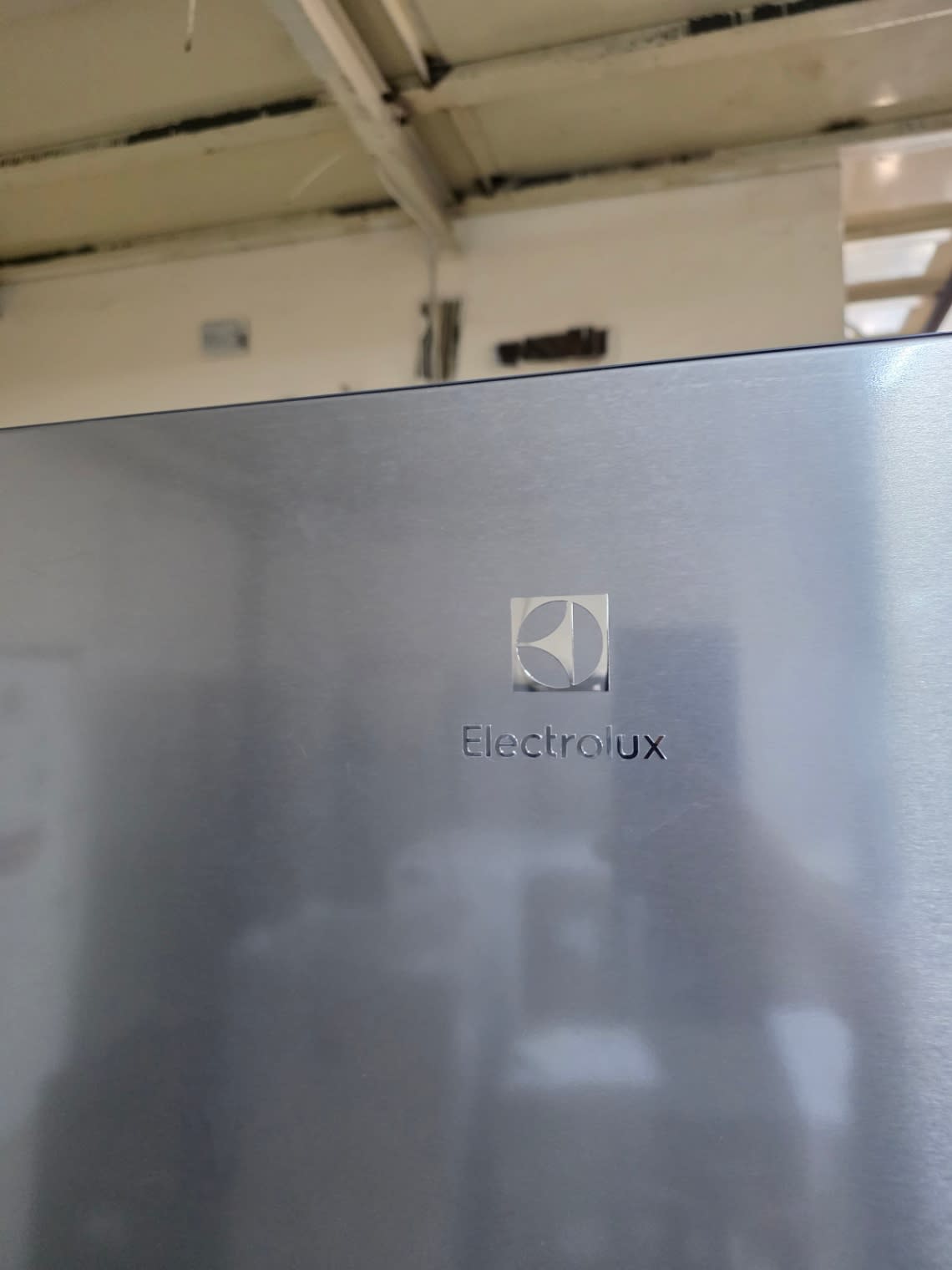 Electrolux brand badge close-up on used bottom-freezer refrigerator at Bufaisal Shop C Ajman