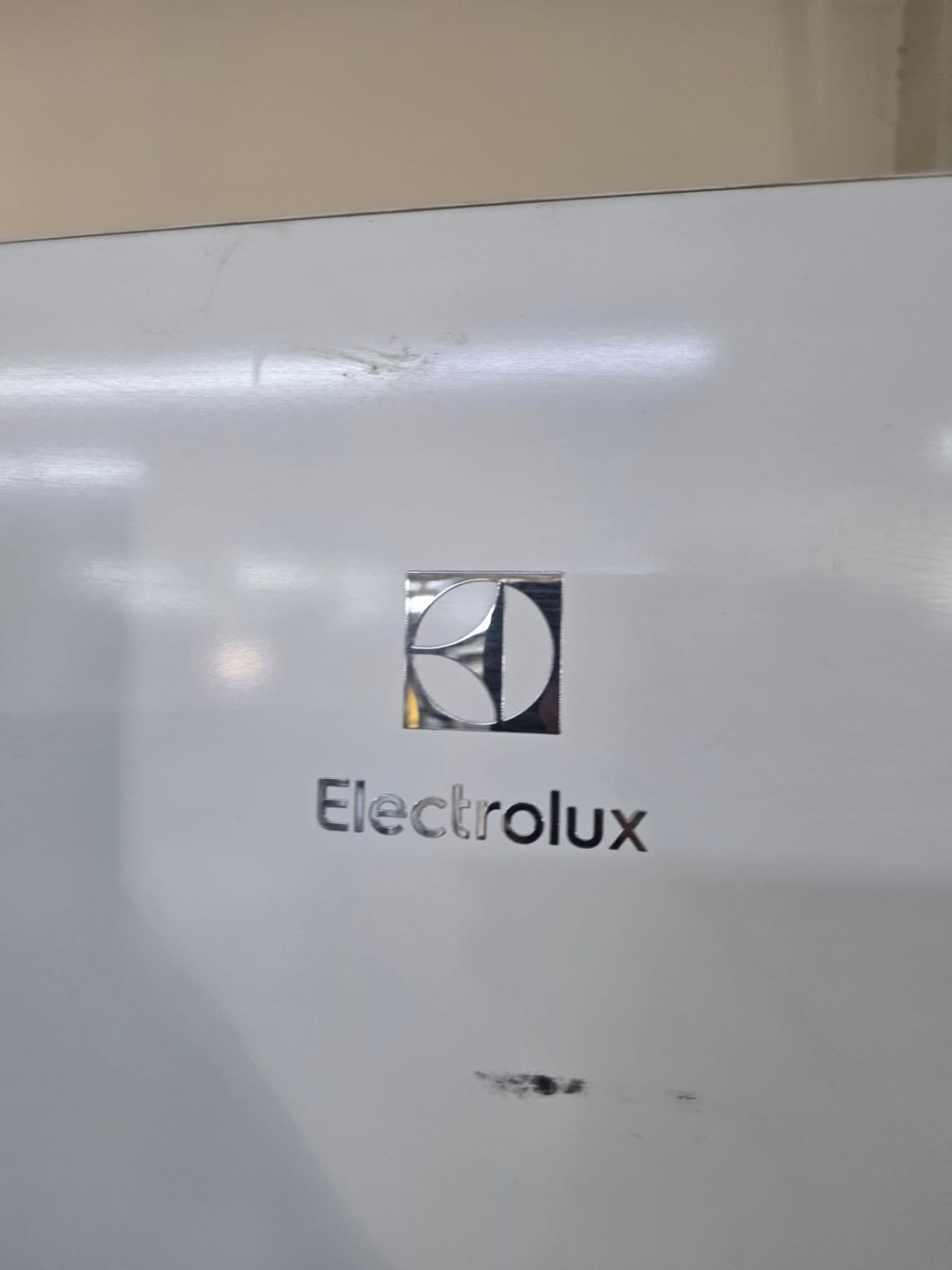 Bufaisal barcode label for used Electrolux single-door upright refrigerator at Shop C Ajman