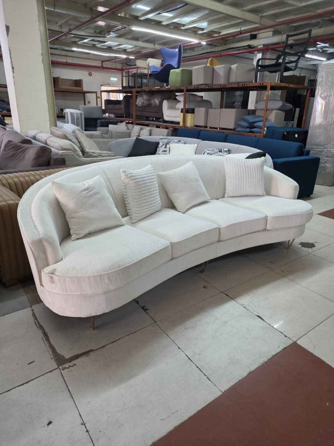 Bufaisal barcode label for used curved 4-seater off-white sofa at Shop C Ajman