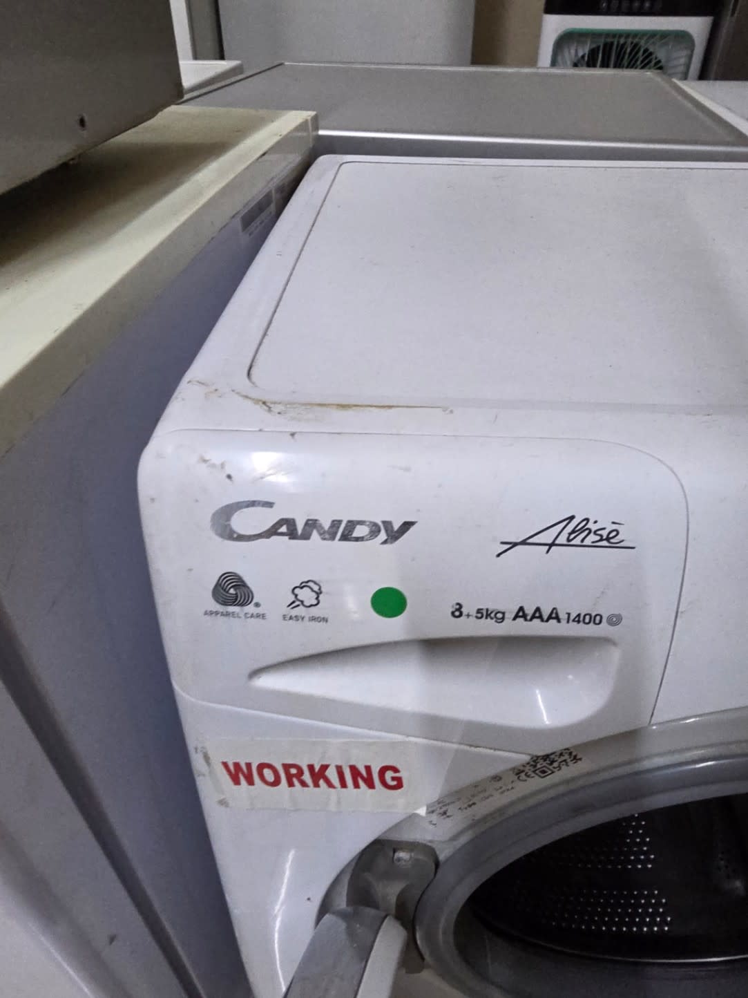 Candy Alisé fascia close-up showing 8+5kg AAA 1400rpm spec and surface wear on panel