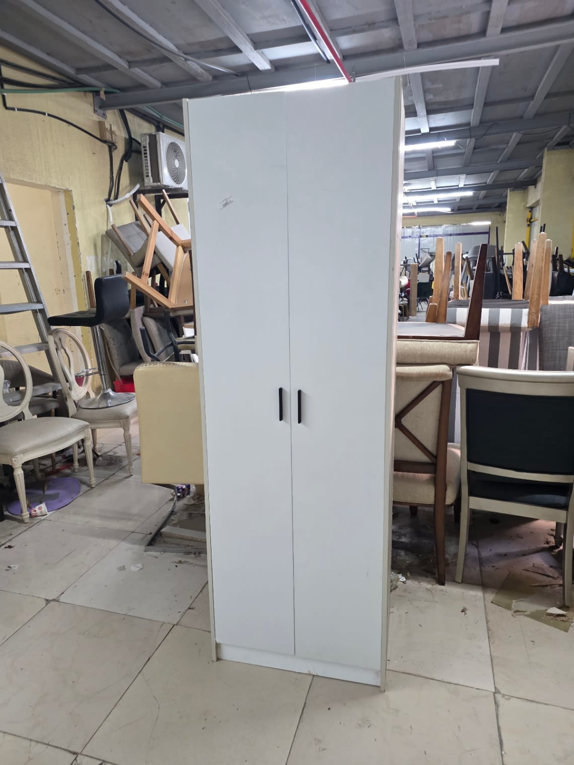 Bufaisal barcode label for used 2-door white wardrobe at Shop C Ajman