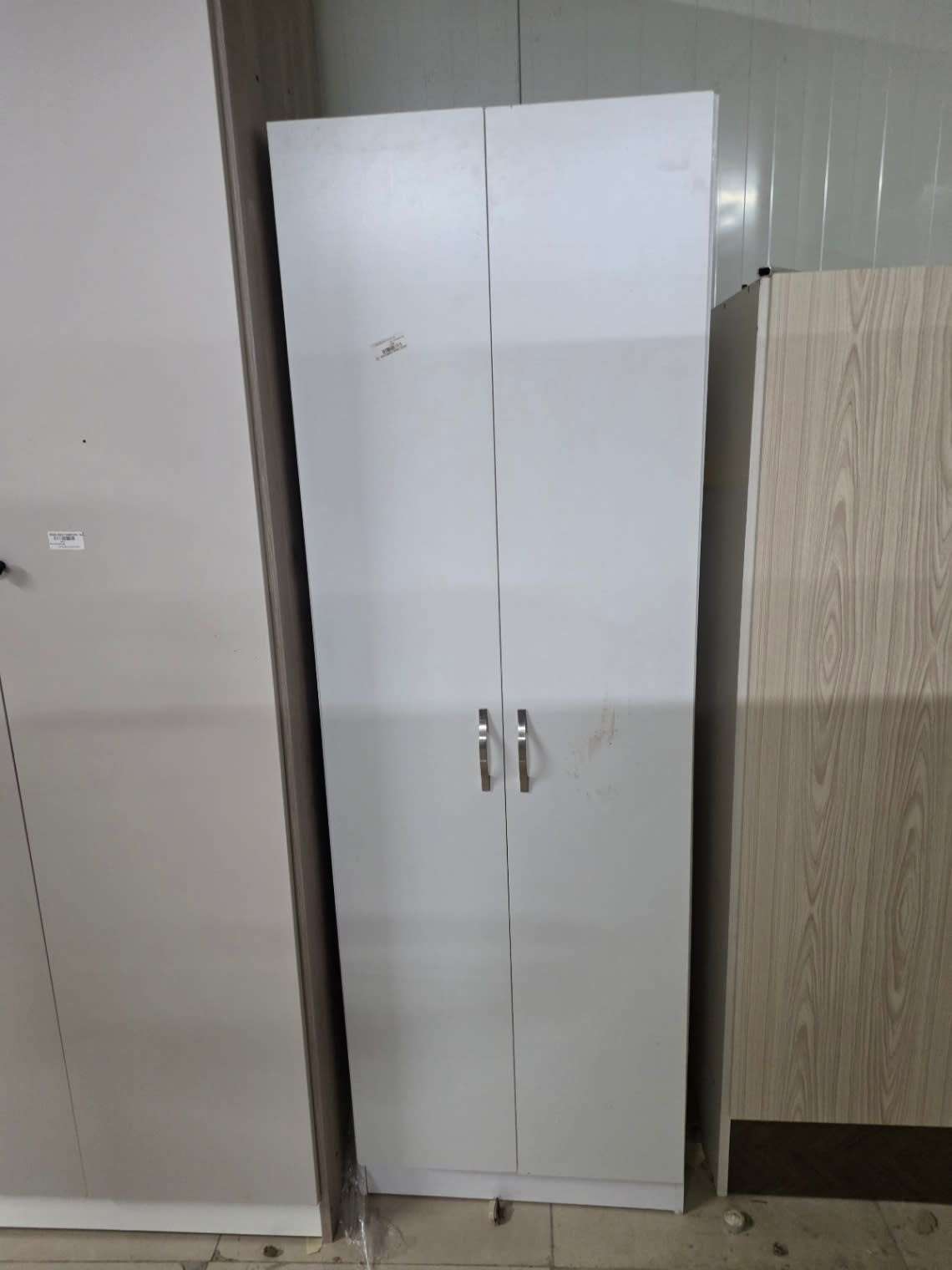 Barcode label for new white 2-door single wardrobe at Bufaisal Shop C Ajman