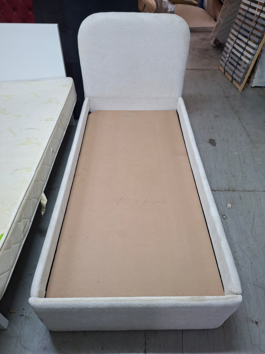 Barcode label photo for used single upholstered bed frame at Bufaisal Ajman — label unreadable