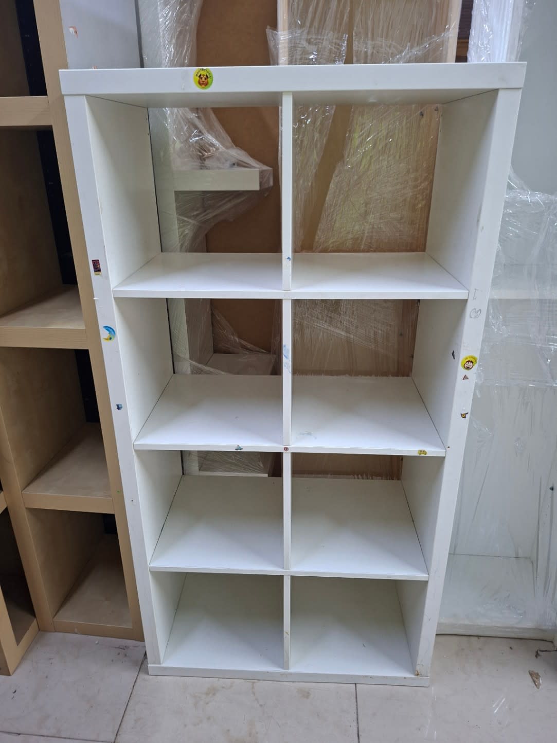 Barcode label photo for used white 8-cube shelving unit at Bufaisal Ajman