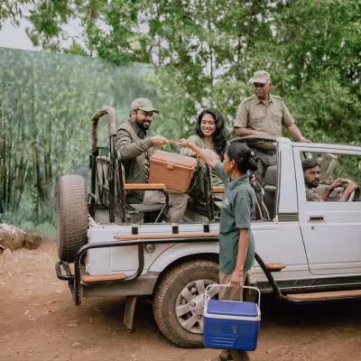 Guests preparing for a safari adventure in an open jeep