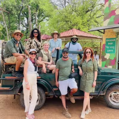 Group of happy guests posing with safari jeep at Limban Resort