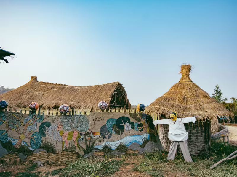 Decorative elements along the outdoor public area near the Limkheda Village entrance at Limban Resort, featuring handcrafted installations, natural materials and warm ambient lighting.