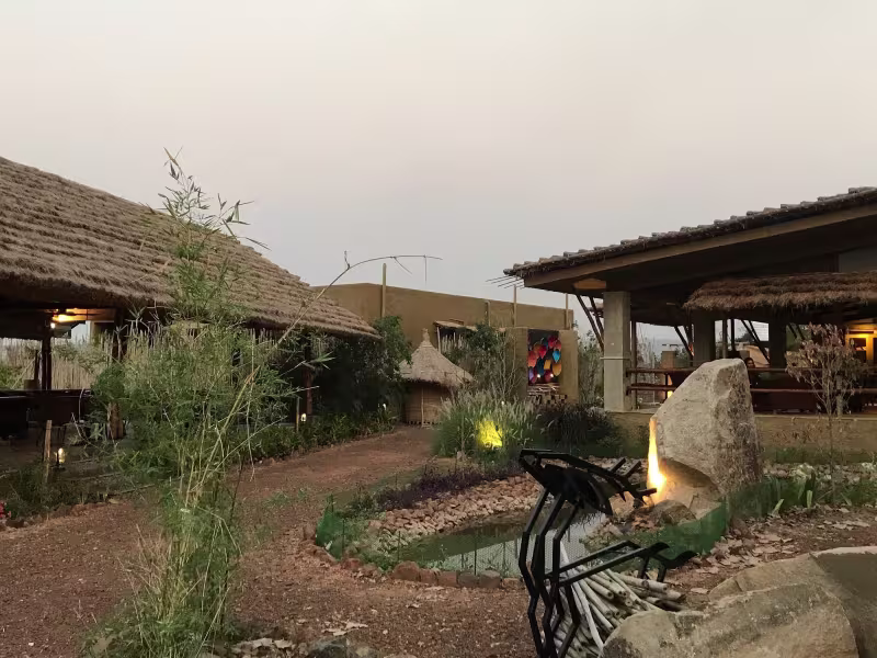 Guest-submitted aerial view of Limban Resort's lobby and common area on an overcast day, showing open thatched roof architecture, landscaped surroundings and resort pathways