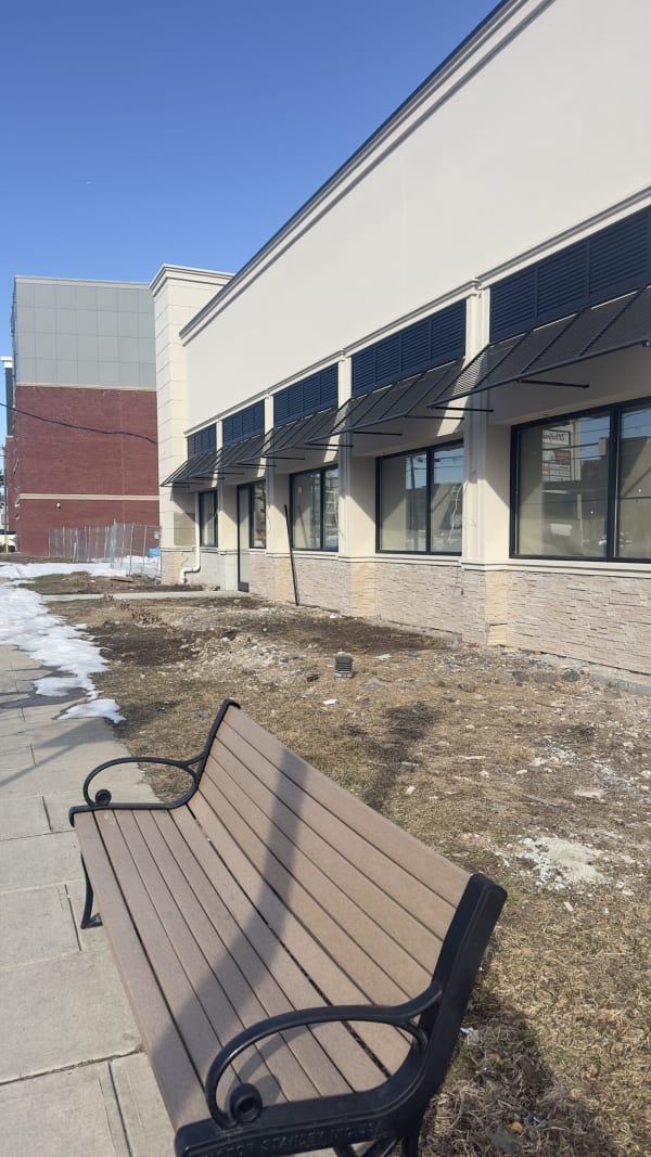 Long view of the Teaneck storefront windows along the building facade