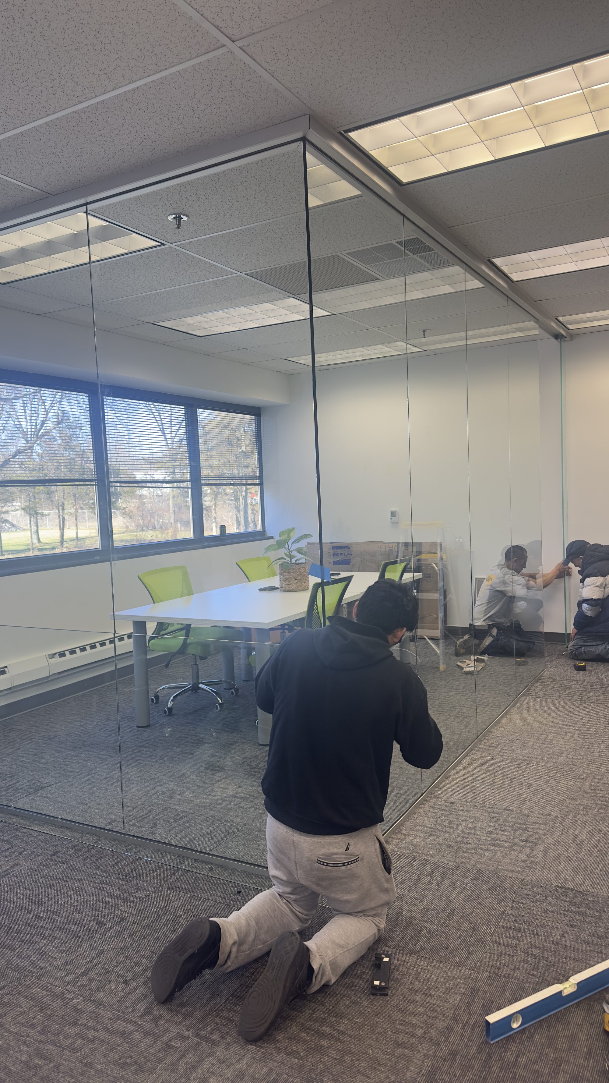 Frameless glass office partition installation in a commercial space
